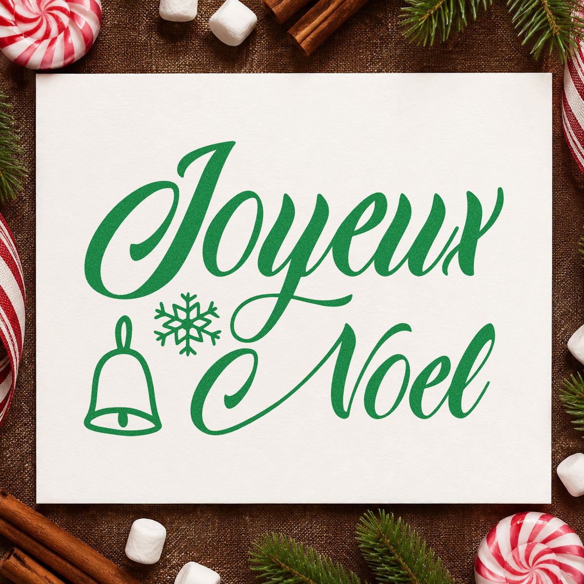 Joyeux Noel Bell Snowflake craft stamp imprinted in green ink on paper, a design suited to framed bistro wall.