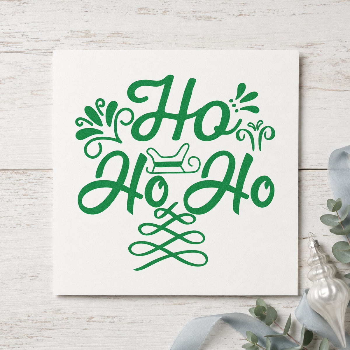 Ho Ho Ho Sleigh craft stamp imprint in green ink on a handmade project, one idea being swag bundle tags.