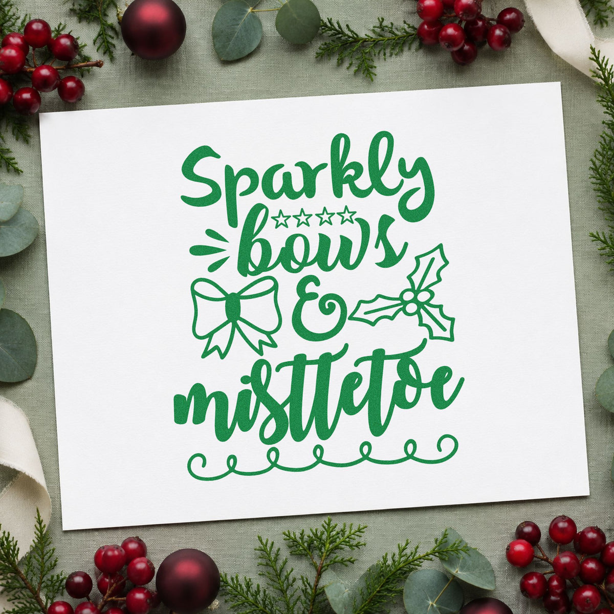 Sparkly Bows And Mistletoe craft stamp imprint in green ink on a handmade project, one idea being boutique wrap cards.