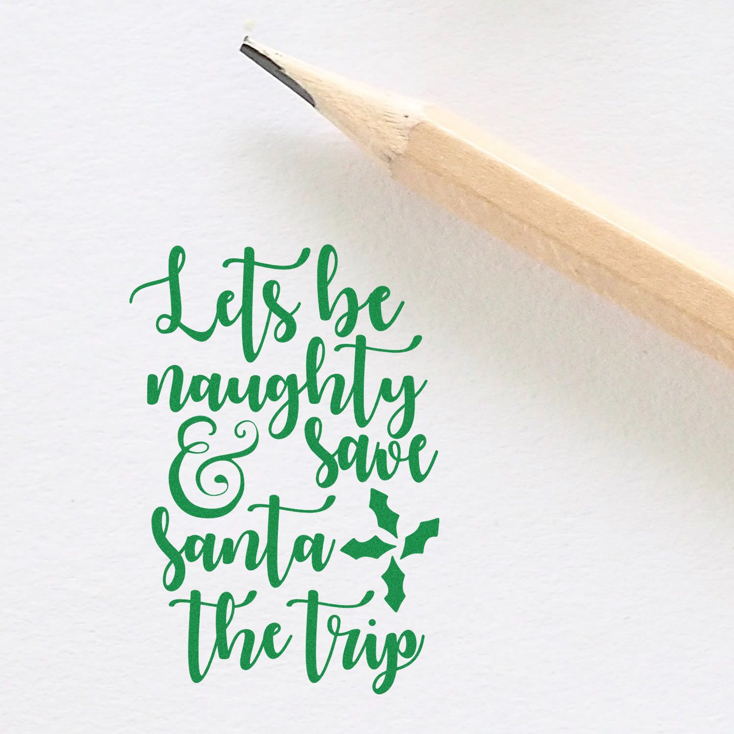 Christmas rubber stamp with Lets be naughty & save Santa the trip holiday phrase and holly accent.