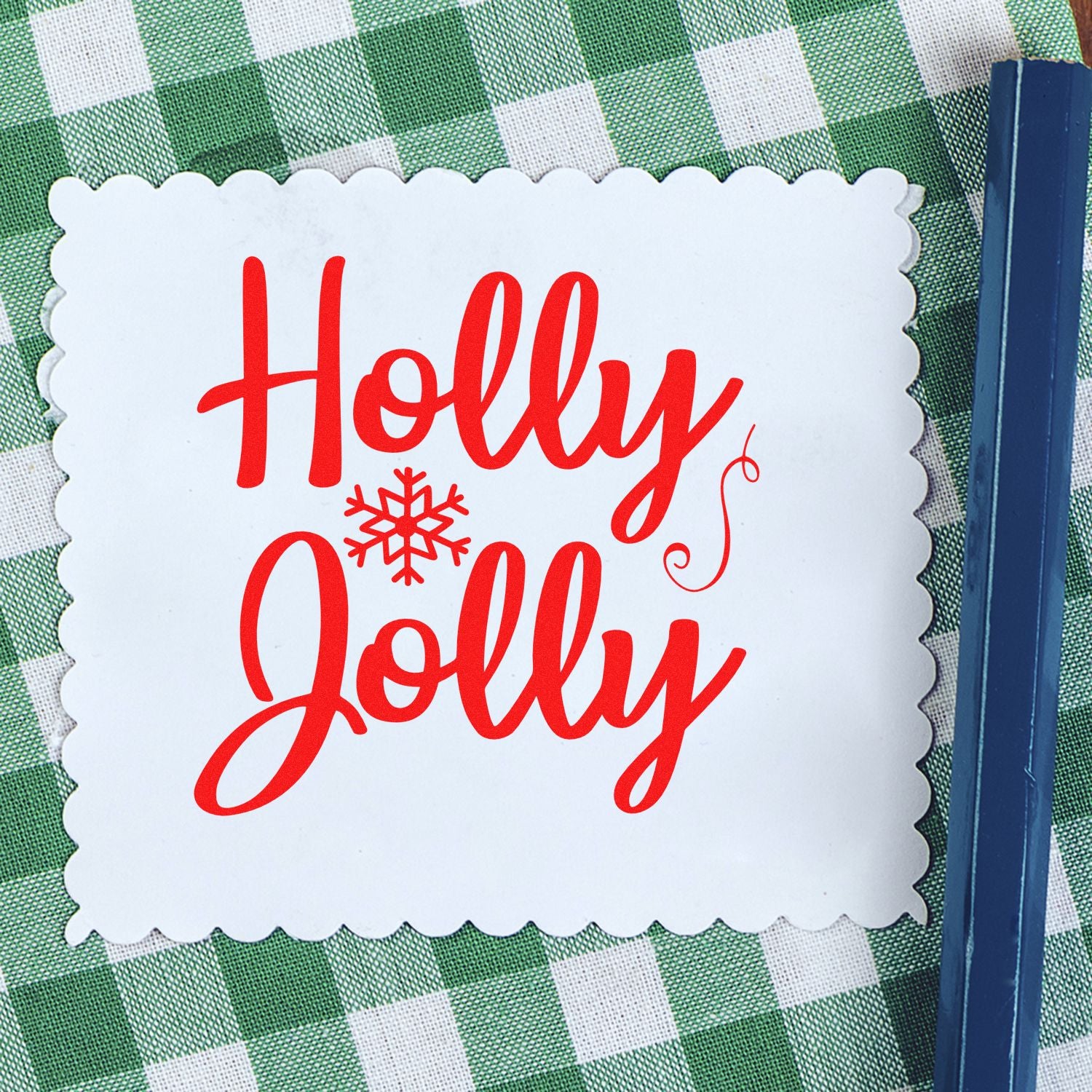 Red Holly Jolly Christmas rubber stamp on scalloped paper, ideal for festive holiday card making.