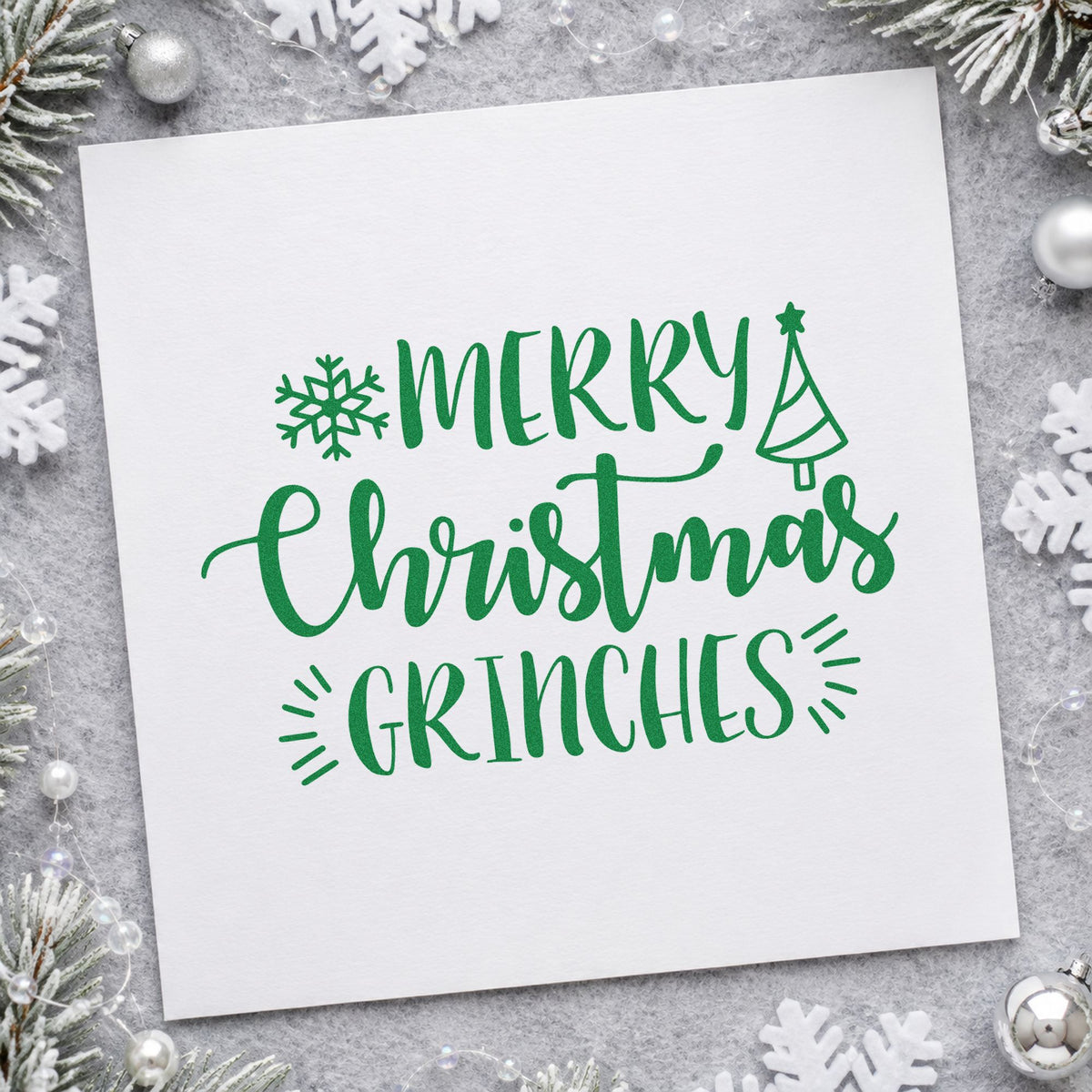 Merry Christmas Grinches craft stamp imprint in green ink on a handmade project, one idea being reluctant gift tags.