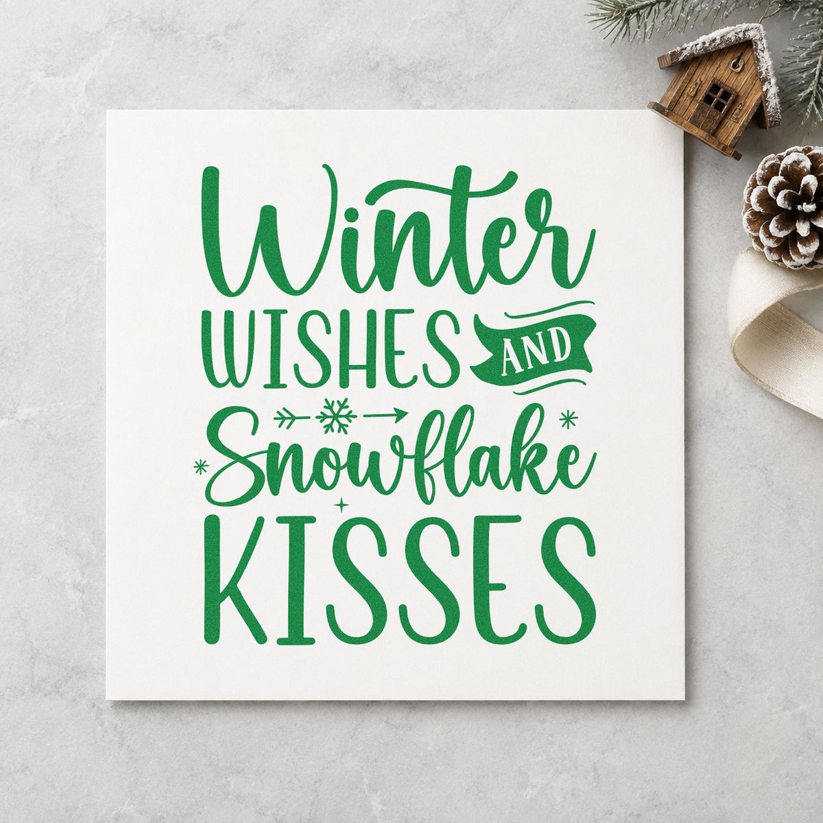 Winter Wishes Snowflake Kisses craft stamp imprint in green ink on a handmade project, one idea being kids party placards.