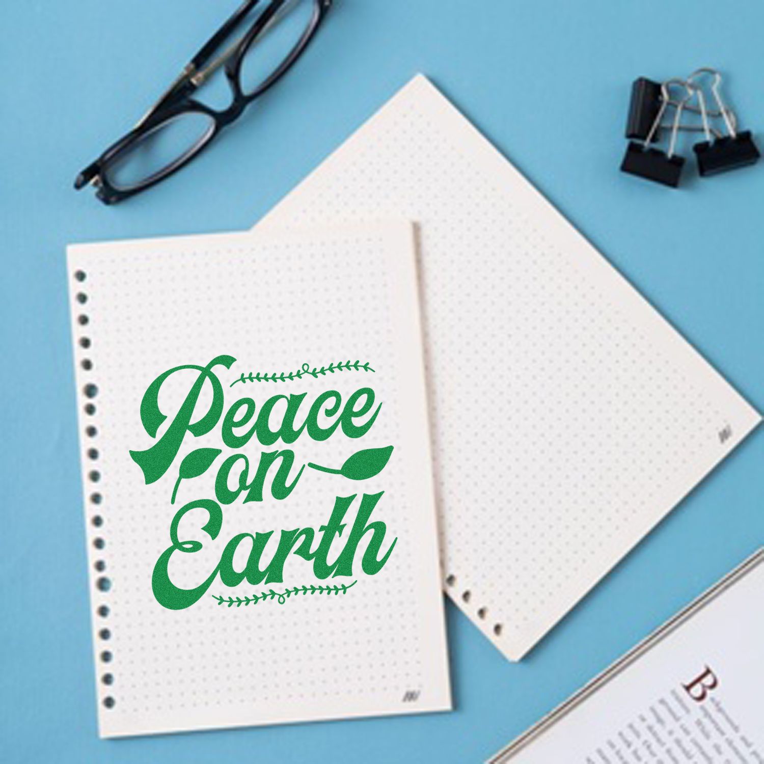 Peace on Earth rubber stamp impression on dotted notebook paper for holiday cards and stationery