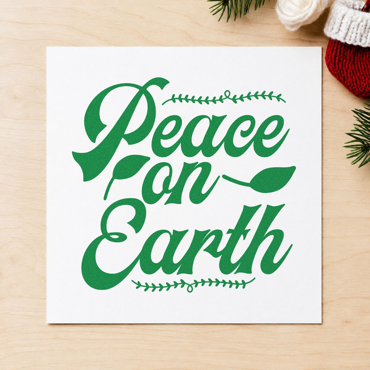 Peace On Earth Leaf Borders craft stamp imprint in green ink on a handmade project, one idea being edge trim gift tags.