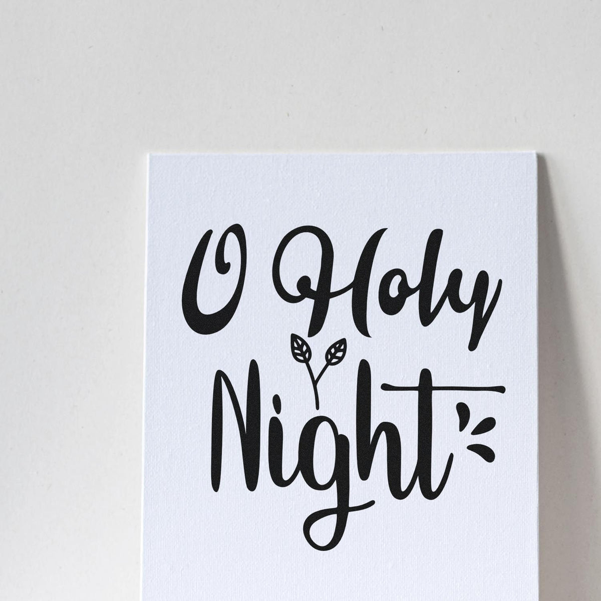 Premium Wooden O Holy Night Leaves Lettering Stamp - Vintage Pro imprint stamped in black ink. "O Holy Night" appears in bold flowing lettering with small leaf and stroke accents.