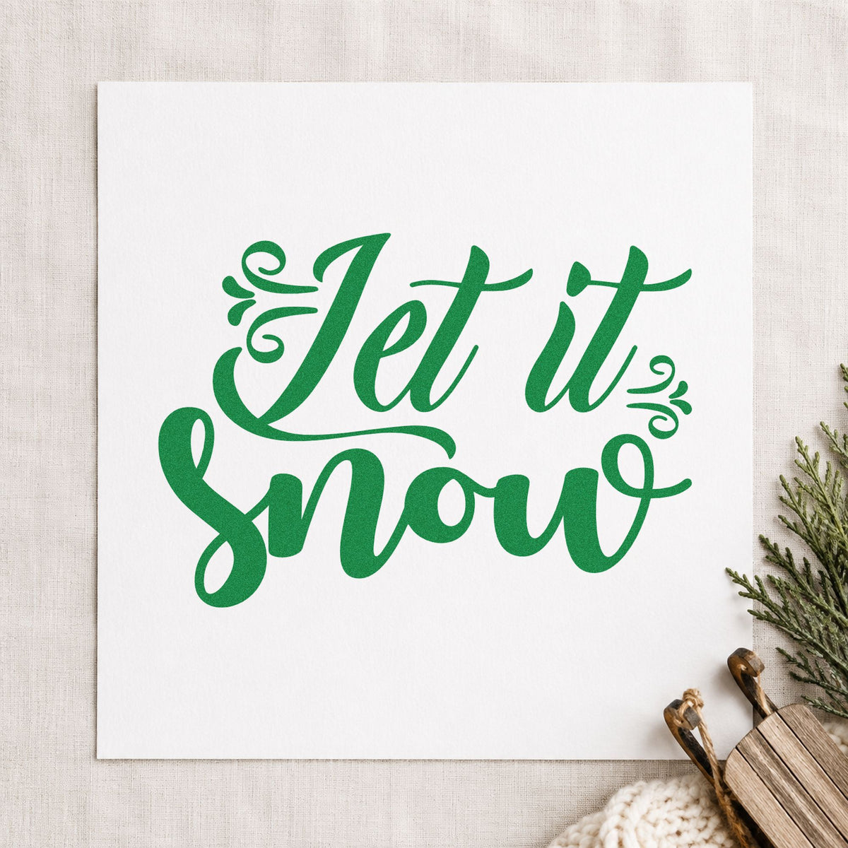 Let It Snow Decorative Script craft stamp imprint in green ink on a handmade project, one idea being place setting slips.