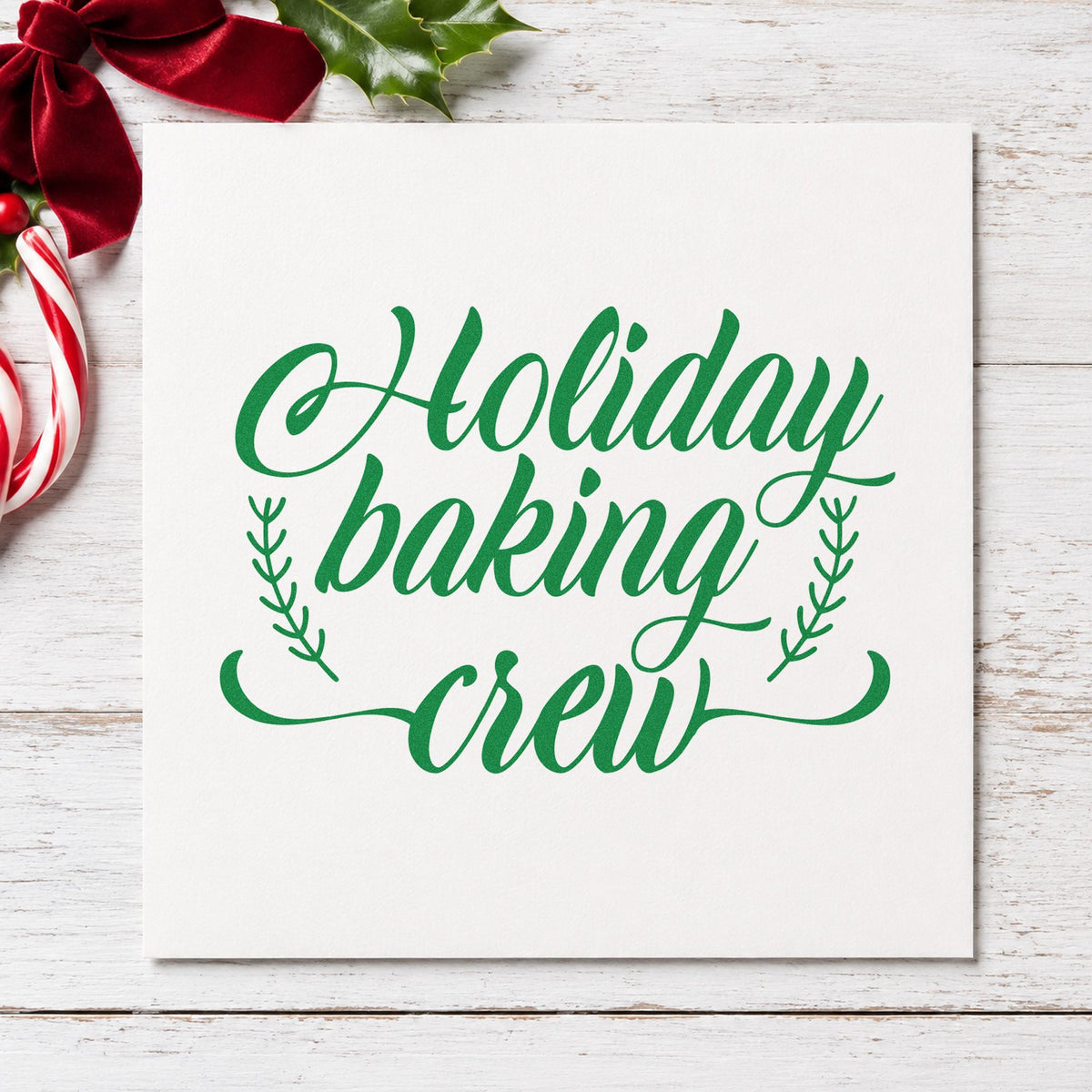 Holiday Baking Crew Sprigs craft stamp imprinted in green ink on paper, a design suited to framed bakery window.