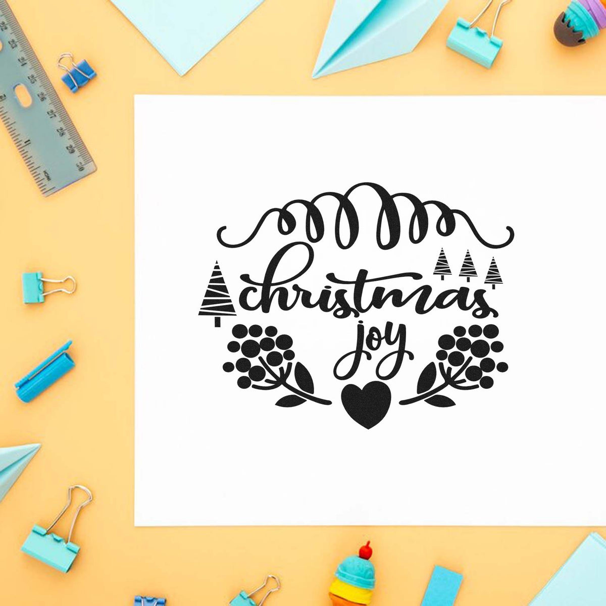 Christmas Joy Berry Framed Lettering Stamp - Premium Vintage Pro Wooden imprint stamped in black ink. "Christmas Joy" appears between a looping flourish, tiny trees, berry branches, and a heart.