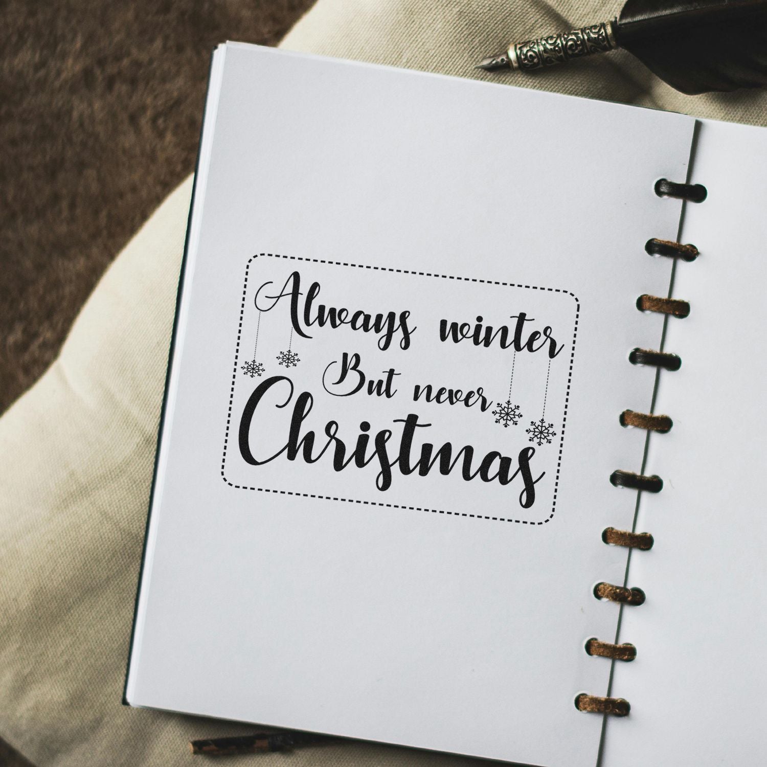 Christmas sentiment rubber stamp design with winter quote Always winter, but never Christmas and snowflake accents.