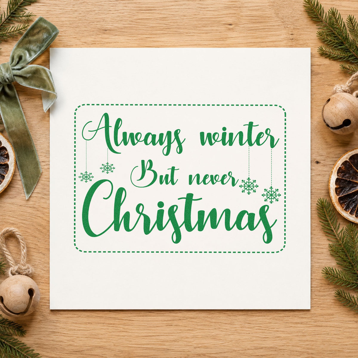Always Winter Never Christmas craft stamp imprinted in green ink on paper, a design suited to framed library nook.