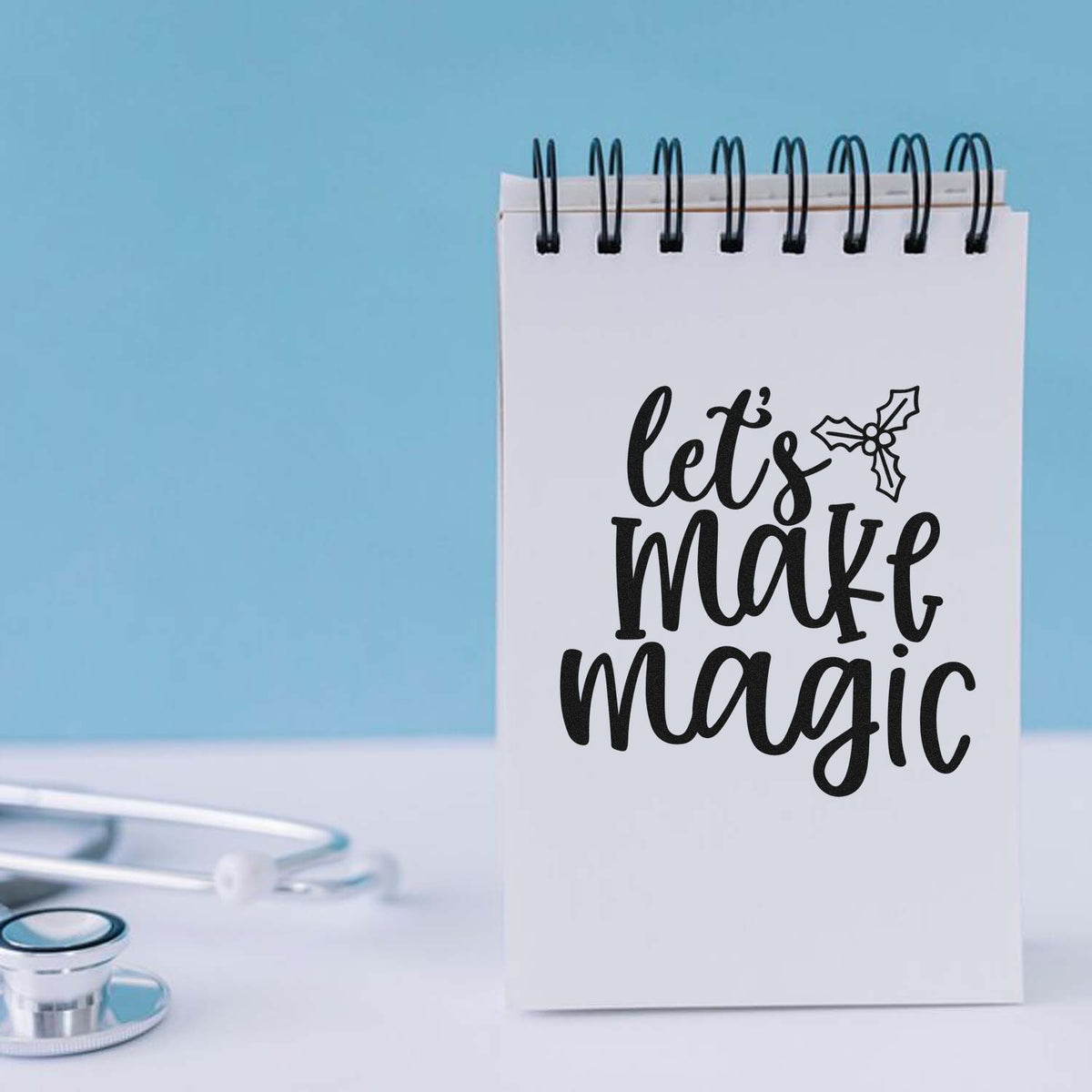 Let's Make Magic Holly Premium Wooden Stamp - Vintage Pro imprint stamped in black ink. "Let's Make Magic" appears in thick hand-drawn script with a holly sprig.