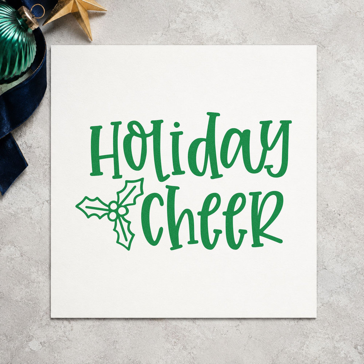 Holiday Cheer Holly craft stamp imprint in green ink on a handmade project, one idea being finished hang tags.
