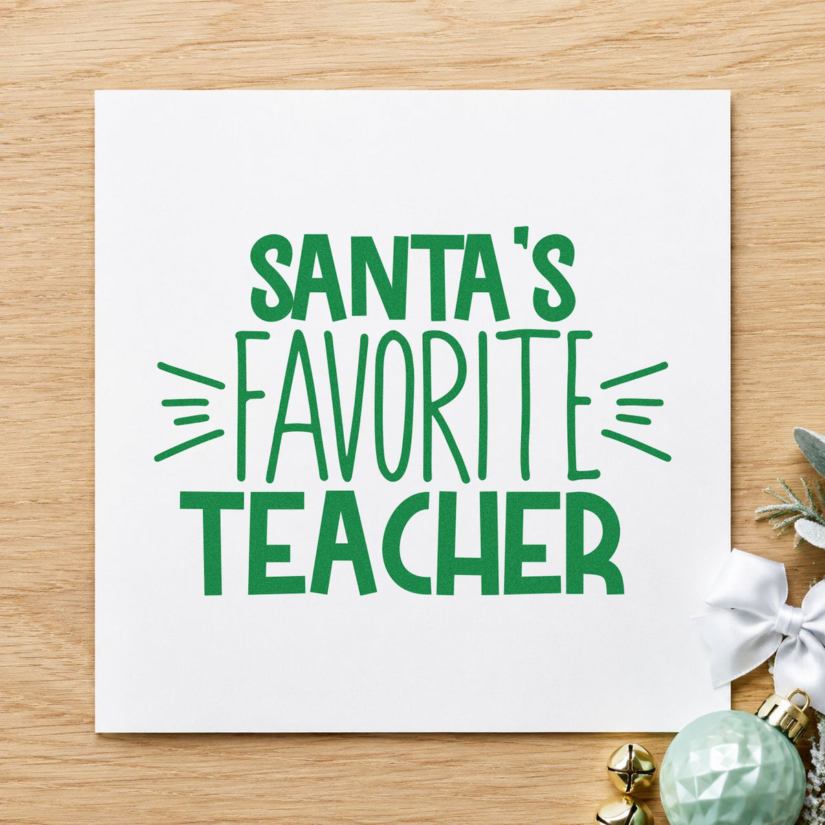 Santa's Favorite Teacher craft stamp imprint in green ink on a handmade project, one idea being prize ribbon tags.
