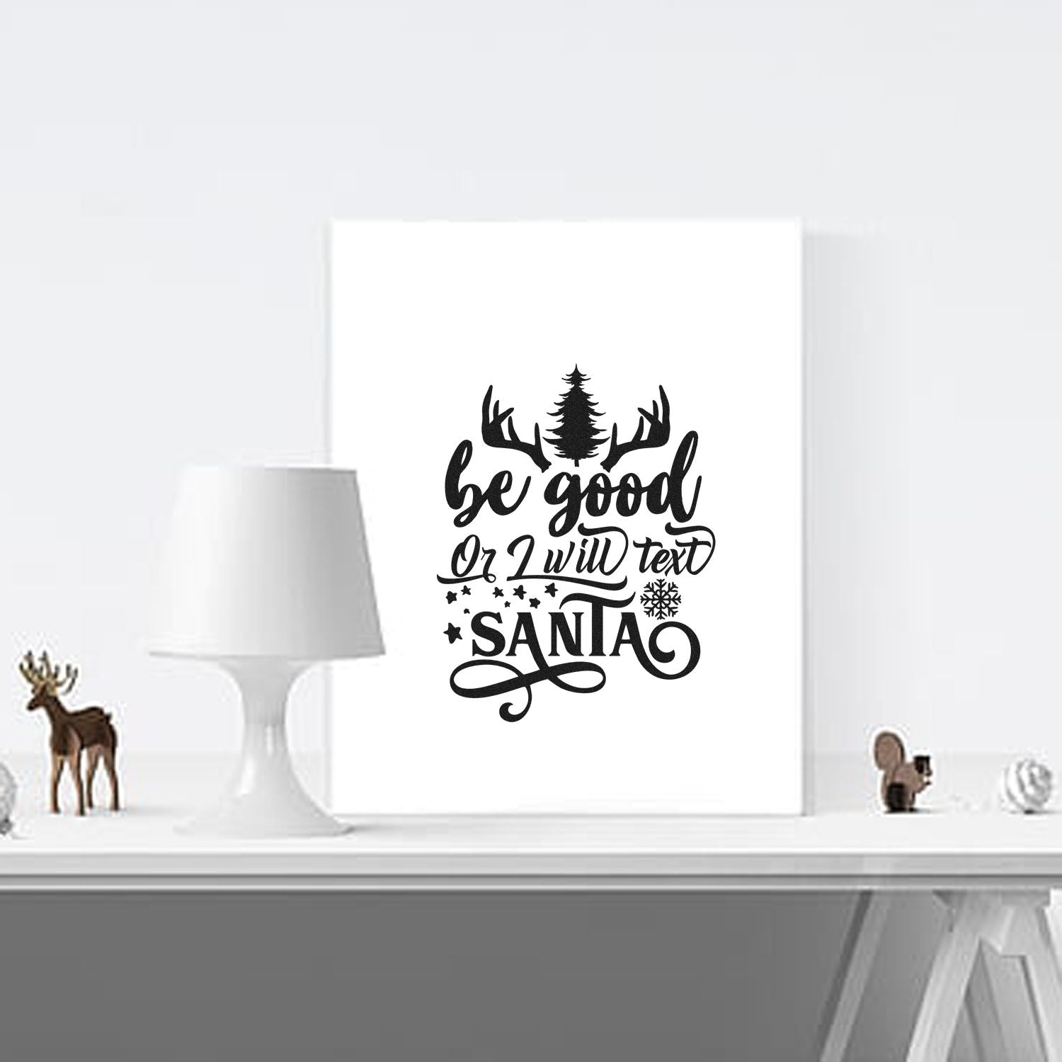 Christmas rubber stamp design with Be good or I will text Santa quote, antlers, pine tree, and snowflake accents.