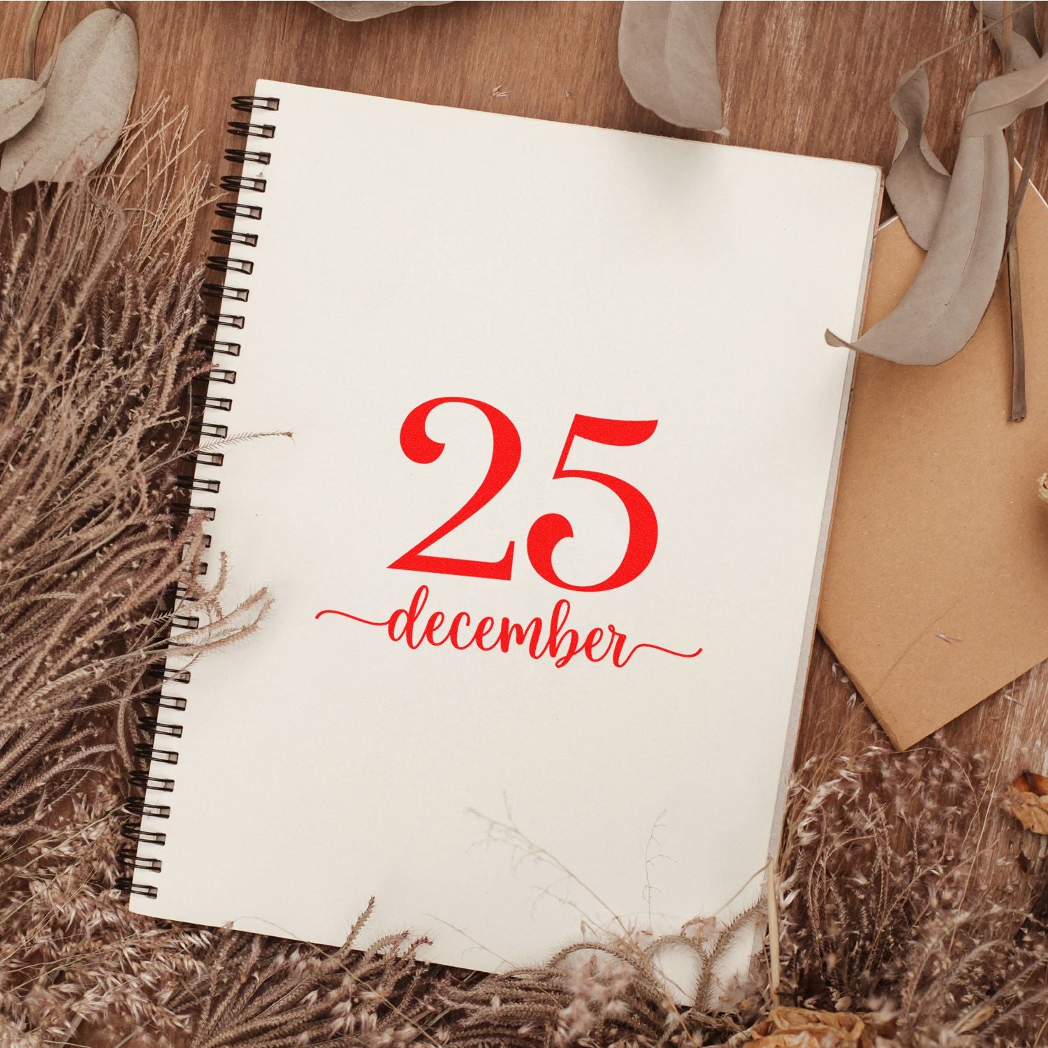 Red 25 December rubber stamp on a spiral notebook, ideal for holiday journaling, planners, and date stamping.