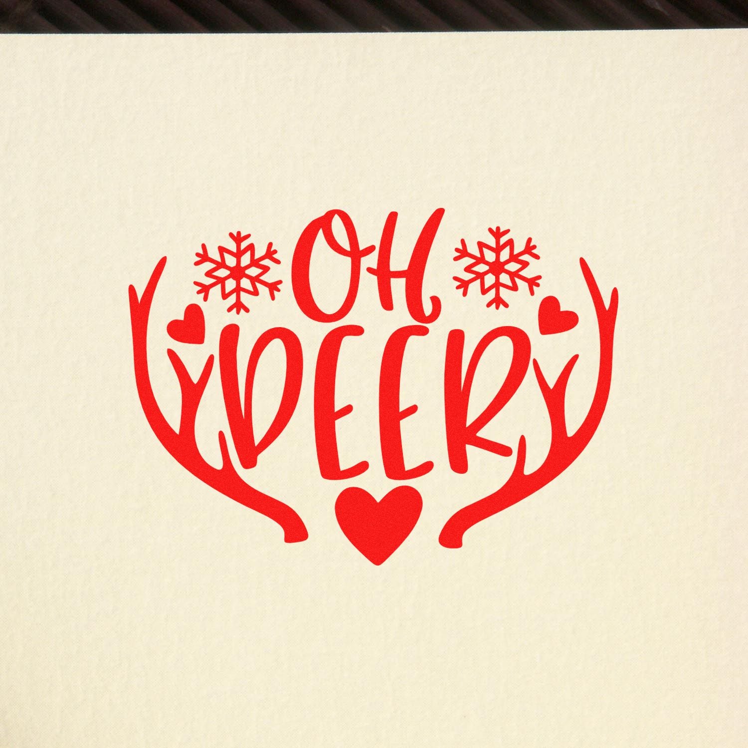 Red Oh Deer Christmas rubber stamp design with antlers, snowflakes, and hearts for holiday cards and crafts.