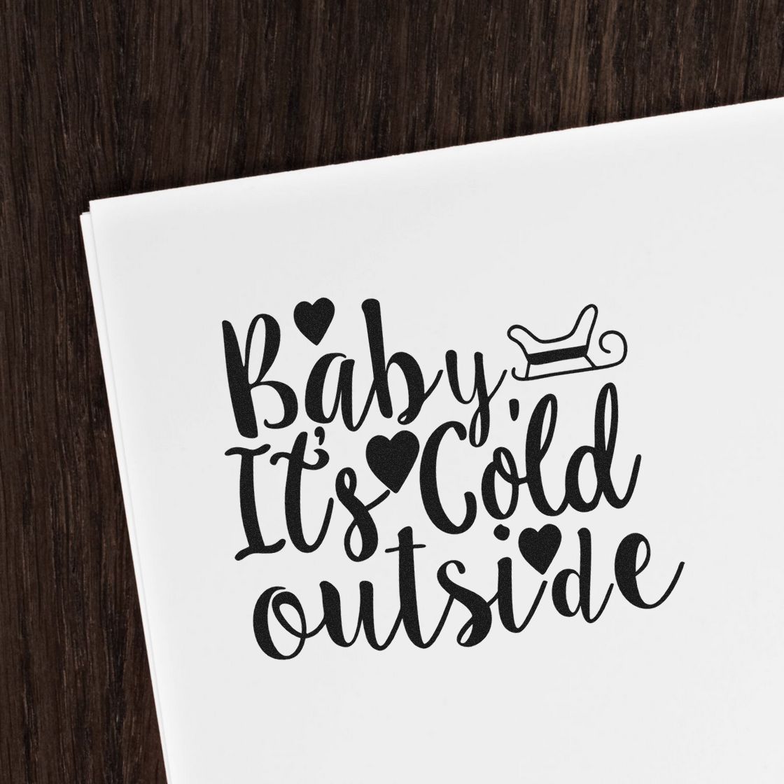Baby Its Cold Outside rubber stamp on white paper with sleigh icon, ideal for winter holiday card making and craft projects.