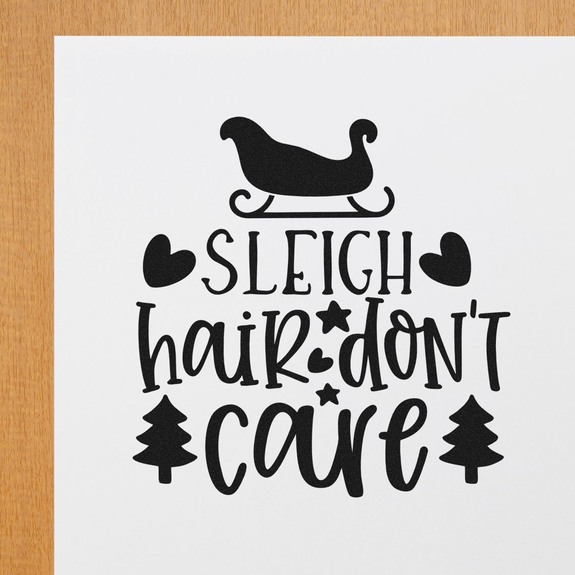 Christmas rubber stamp design with sleigh icon and Sleigh Hair Dont Care holiday text, hearts, and pine trees.