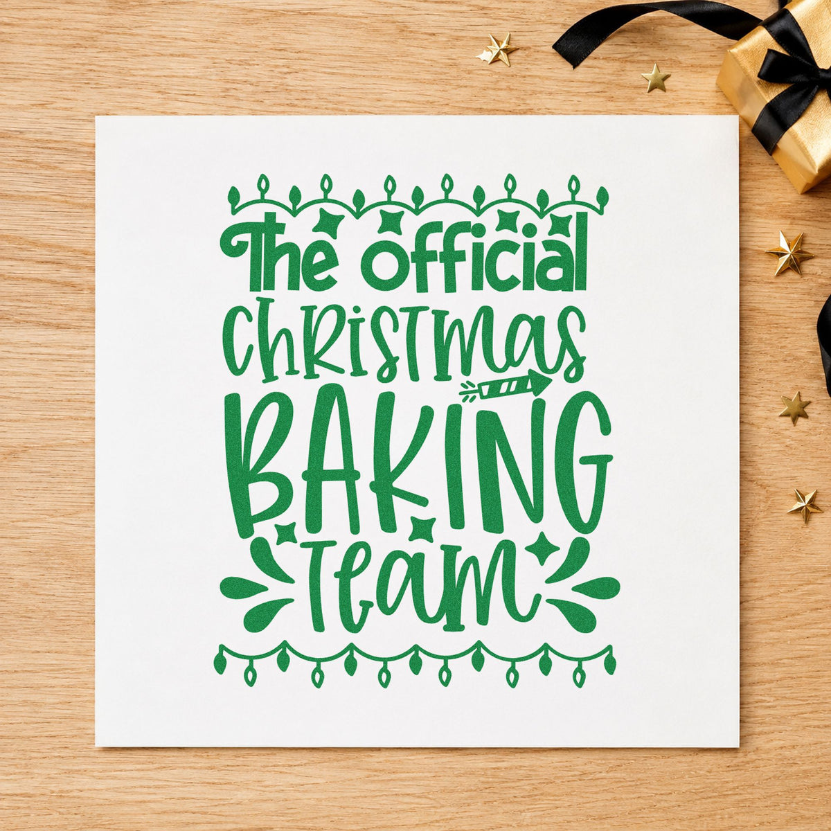 Official Christmas Baking Team craft stamp imprint in green ink on a handmade project, one idea being induction certificates.