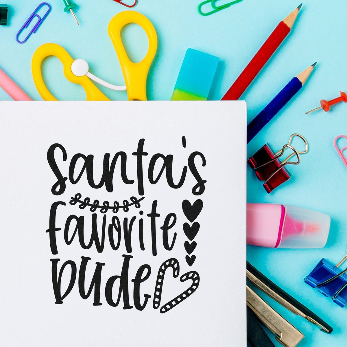 Santa's Favorite Wife Premium Wooden Stamp - Vintage Pro imprint stamped in black ink. "Santa's Favorite Wife" appears in large script with a curled flourish, stacked hearts, and a heart-shaped candy cane.