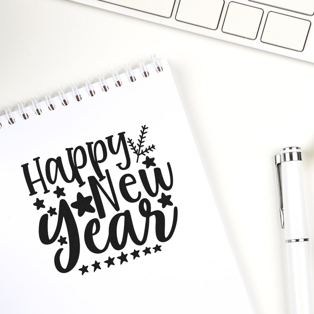 Vintage Pro Happy New Year Stars Premium Wooden Stamp imprint stamped in black ink. The words "Happy new year" are surrounded by stars and a small leafy sprig.