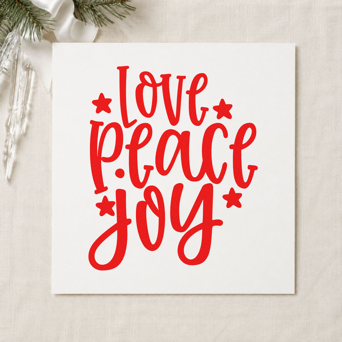 Love Peace Joy Stars rubber stamp shown in red ink, stamped for projects such as spine strip labels.