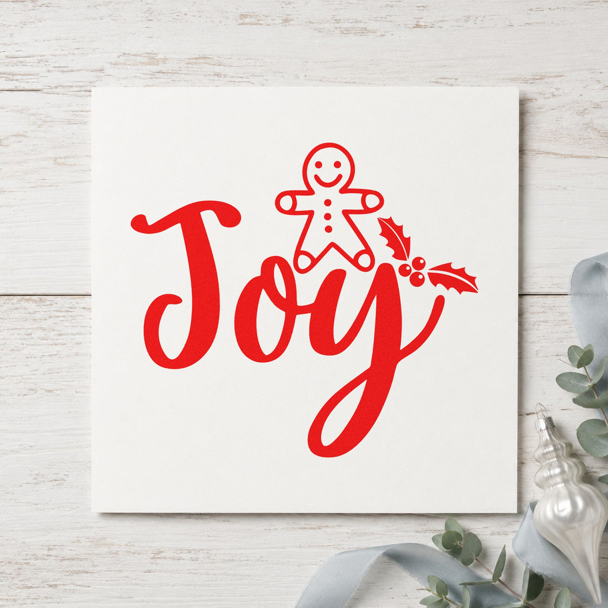 Joy Gingerbread Holly Lettering craft stamp in red ink on cardstock, an easy option for mitt cuff printing.