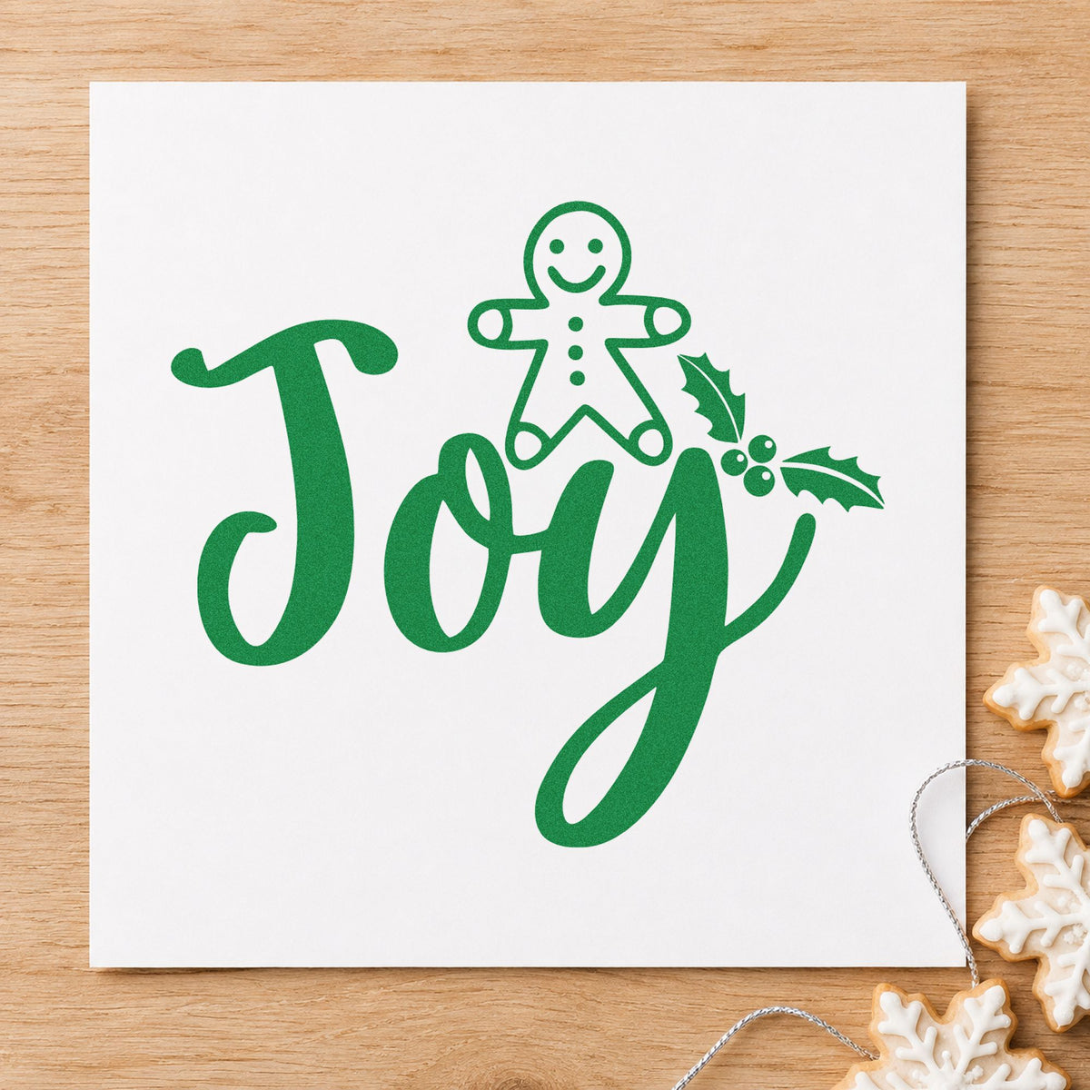 Joy Gingerbread Holly Lettering craft stamp imprint in green ink on a handmade project, one idea being house build cards.