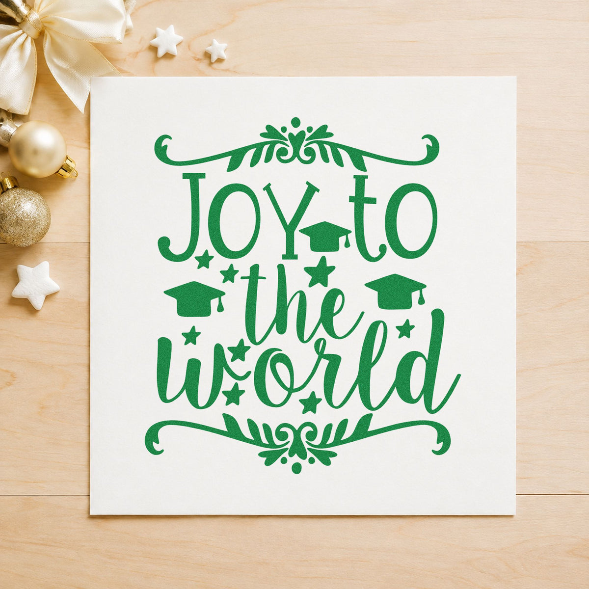 Joy To The World Flourishes craft stamp imprinted in green ink on paper, a design suited to framed diploma wall.