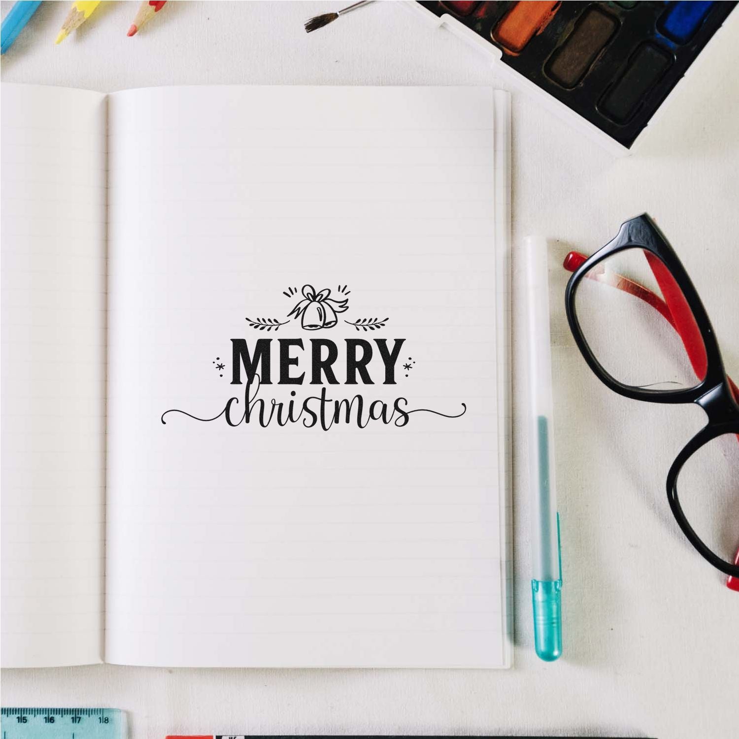 Merry Christmas rubber stamp design on notebook, perfect for holiday card making, journaling, and festive stationery crafts.