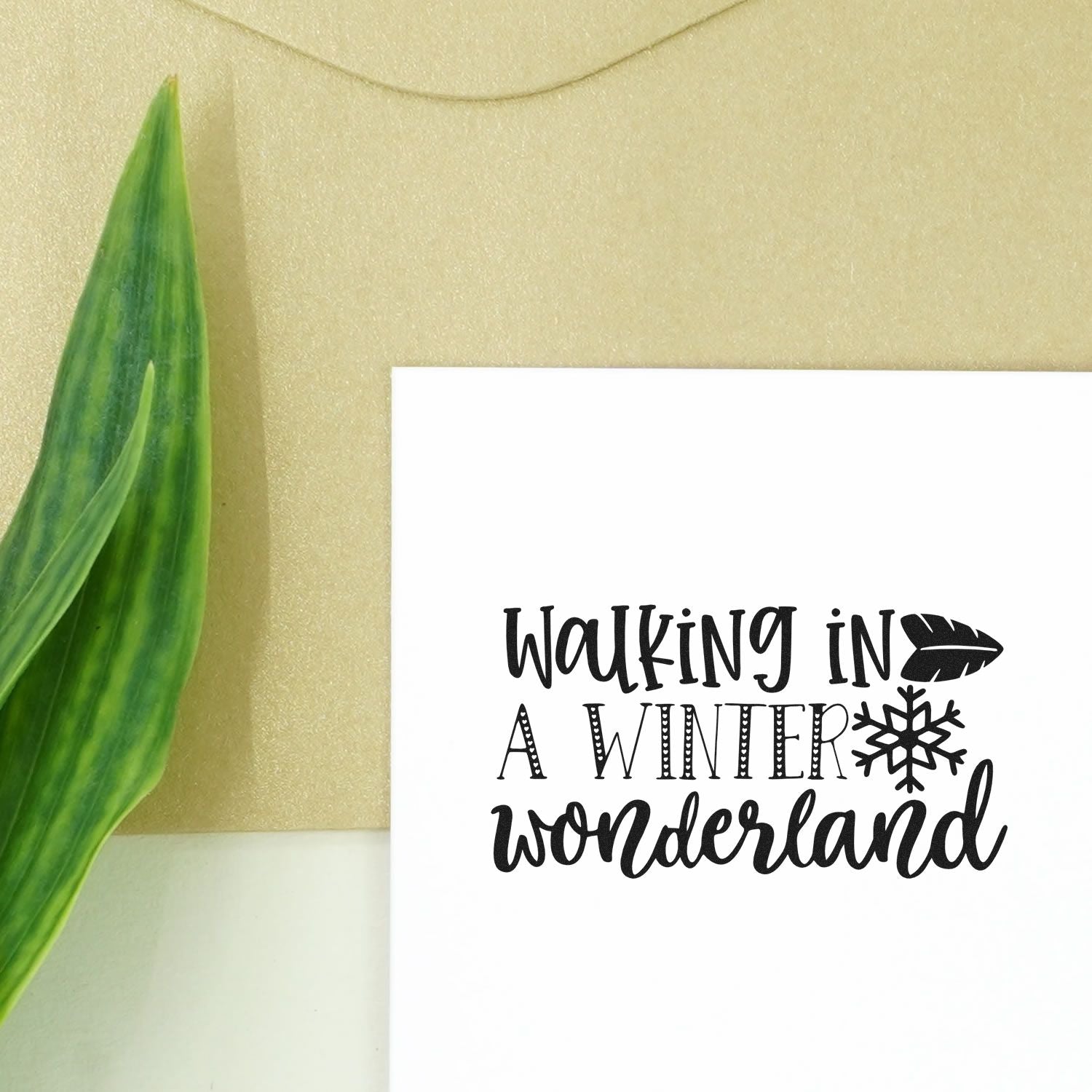 Winter wonderland rubber stamp design with Walking in a Winter Wonderland quote, snowflake and leaf for holiday cards.