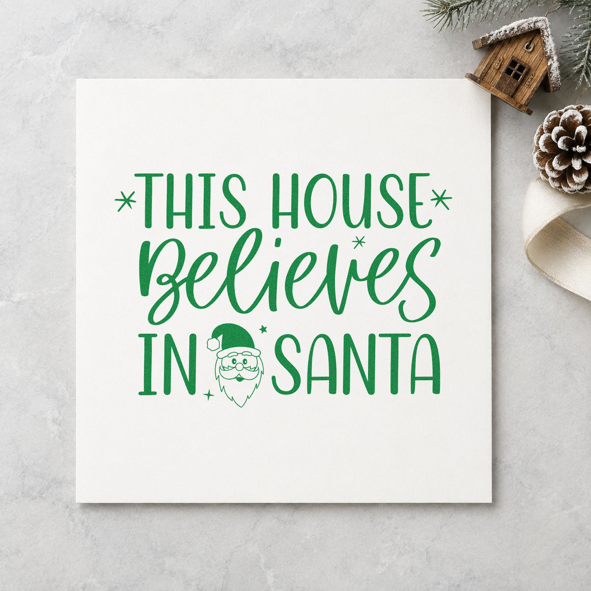 This House Believes In Santa craft stamp imprint in green ink on a handmade project, one idea being gate hanger tags.