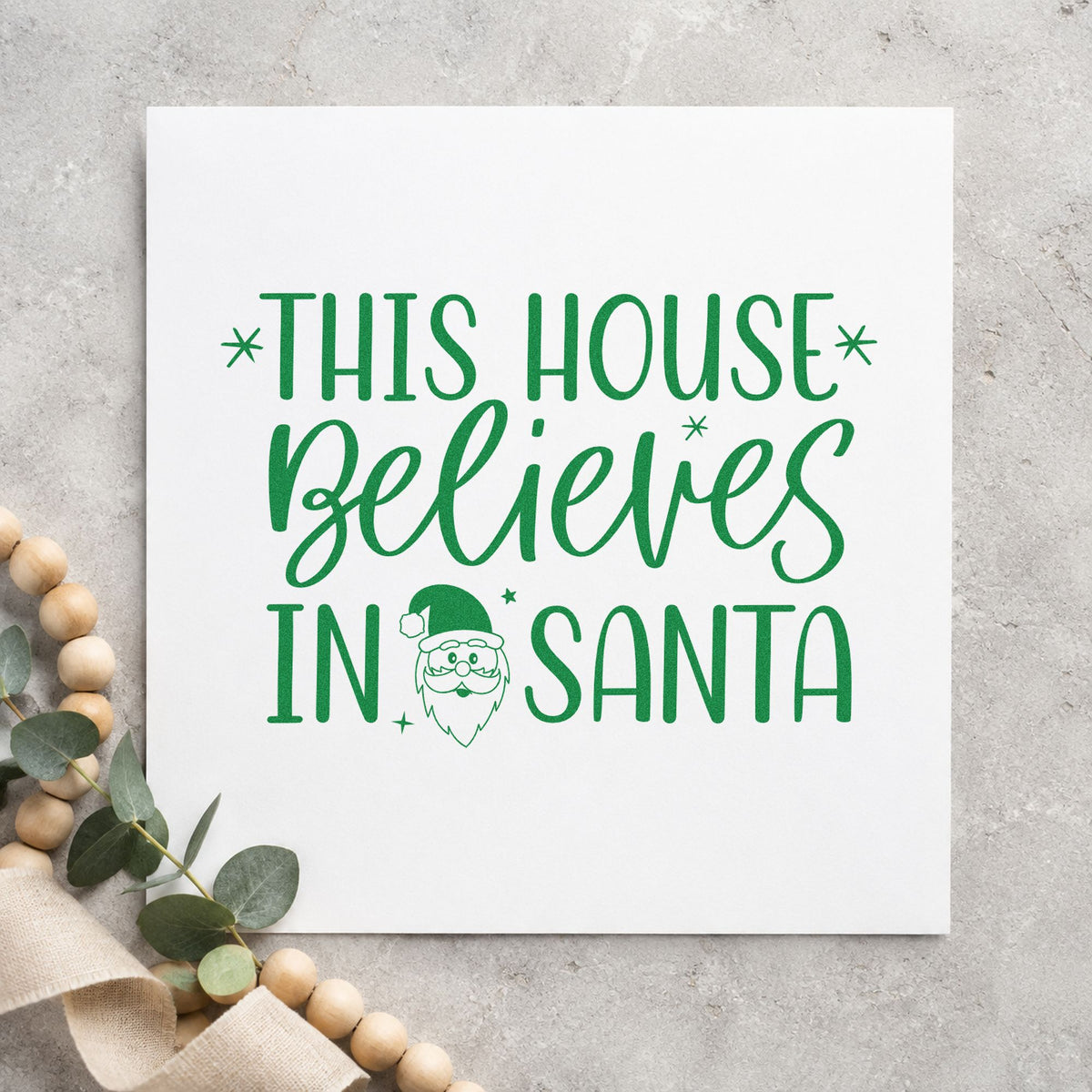 This House Believes In Santa craft stamp imprint in green ink on a handmade project, one idea being street tour cards.