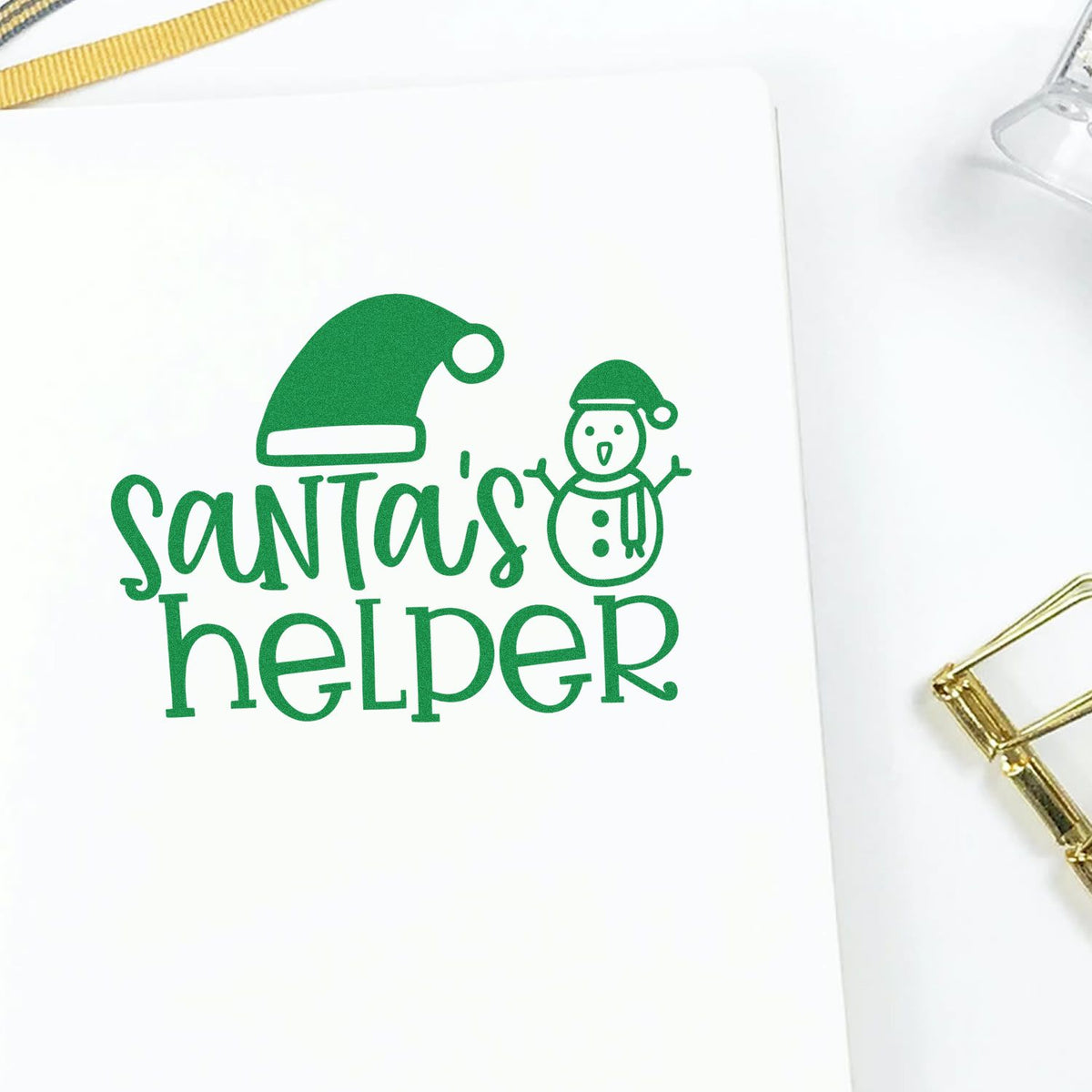 Santa's Helper Hat Snowman rubber stamp shown in green ink, stamped for projects such as snow day album page.