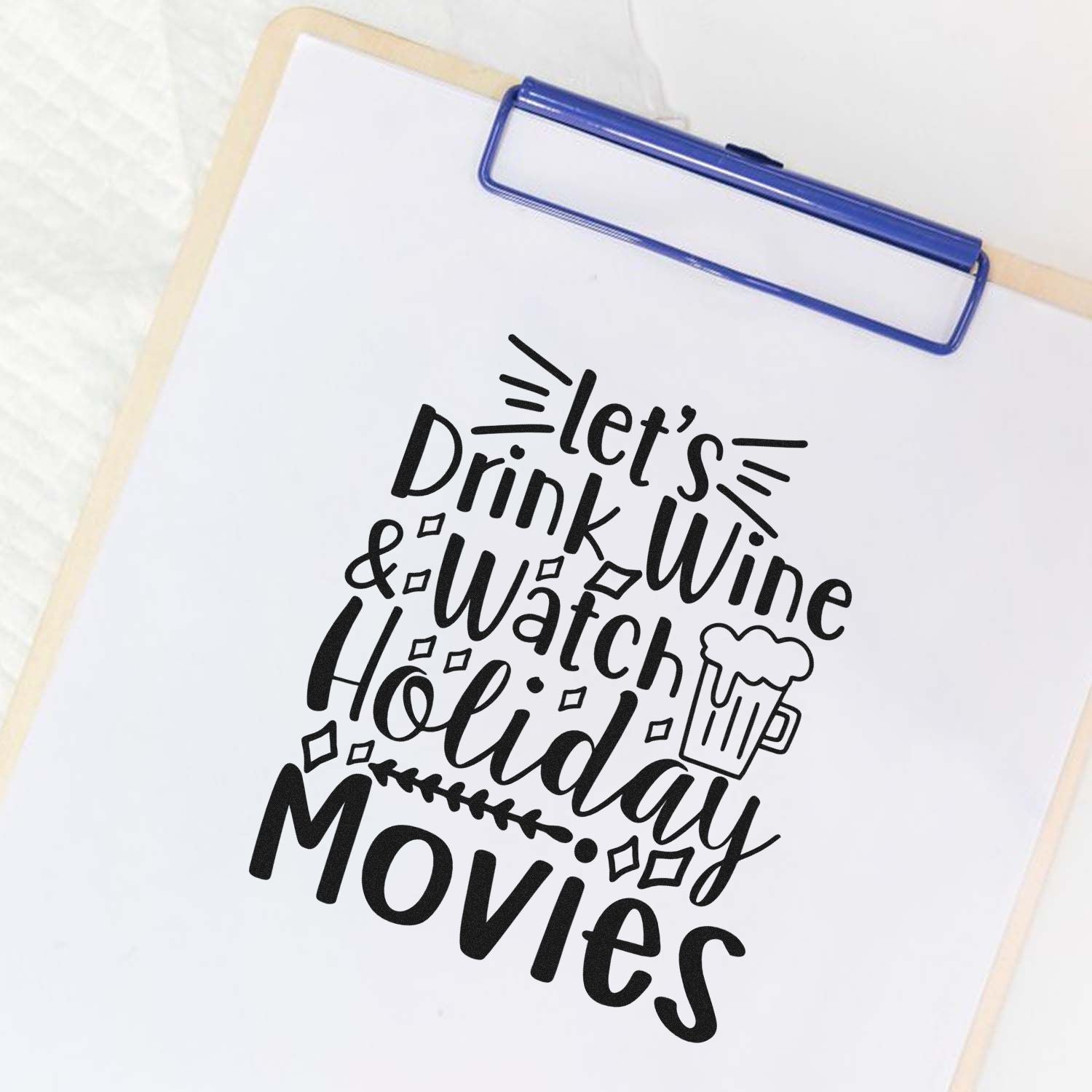Festive rubber stamp design reading Lets Drink Wine & Watch Holiday Movies for holiday crafting and party decor.