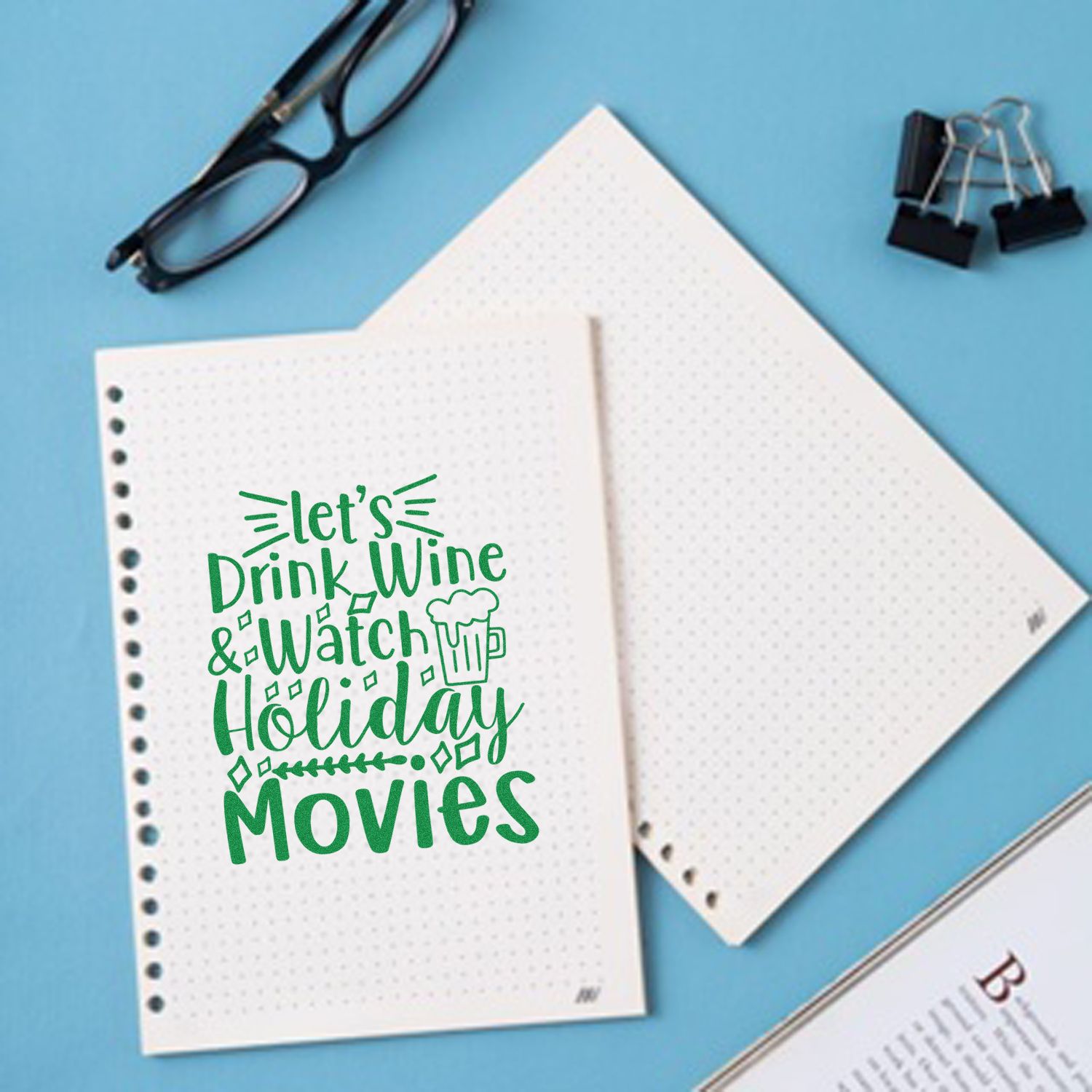 Holiday movie and wine rubber stamp design on notebook paper, perfect for Christmas journaling and festive crafts.