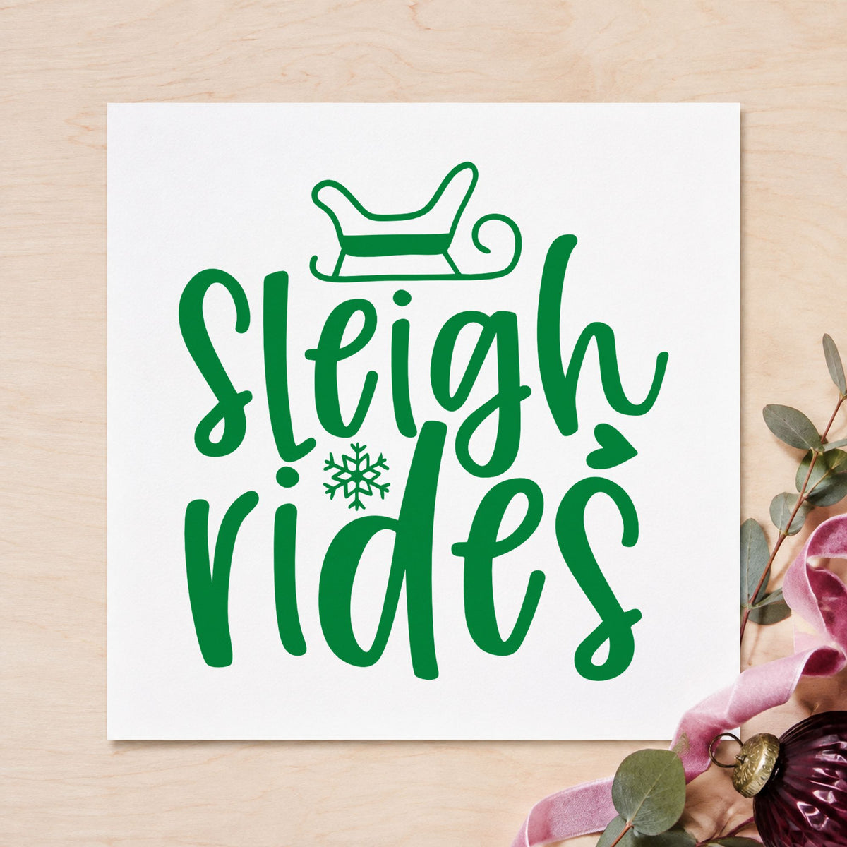Sleigh Rides With Snowflake craft stamp imprint in green ink on a handmade project, one idea being room key tags.