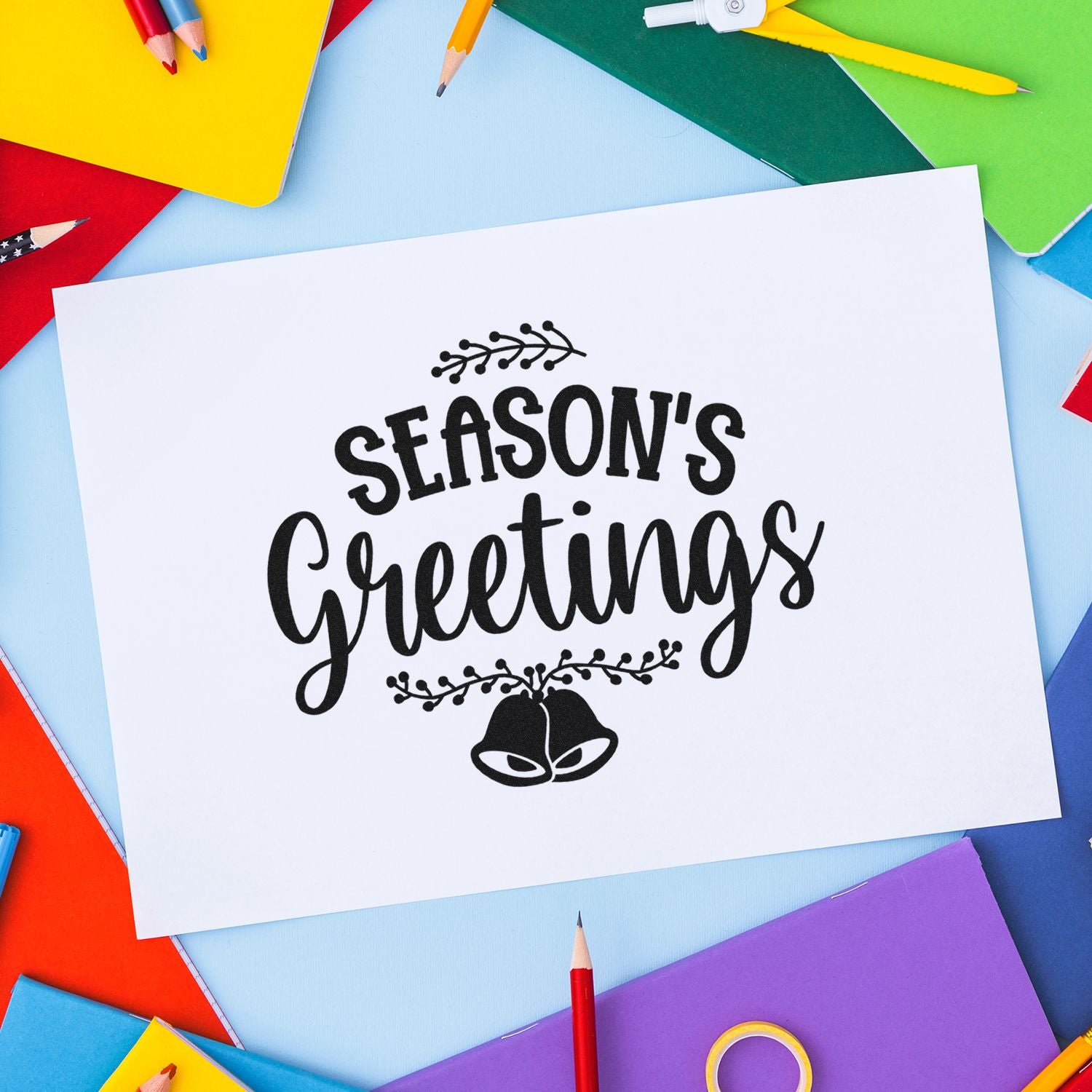 Season's Greetings rubber stamp on white card, ideal for holiday card making and festive paper crafts.