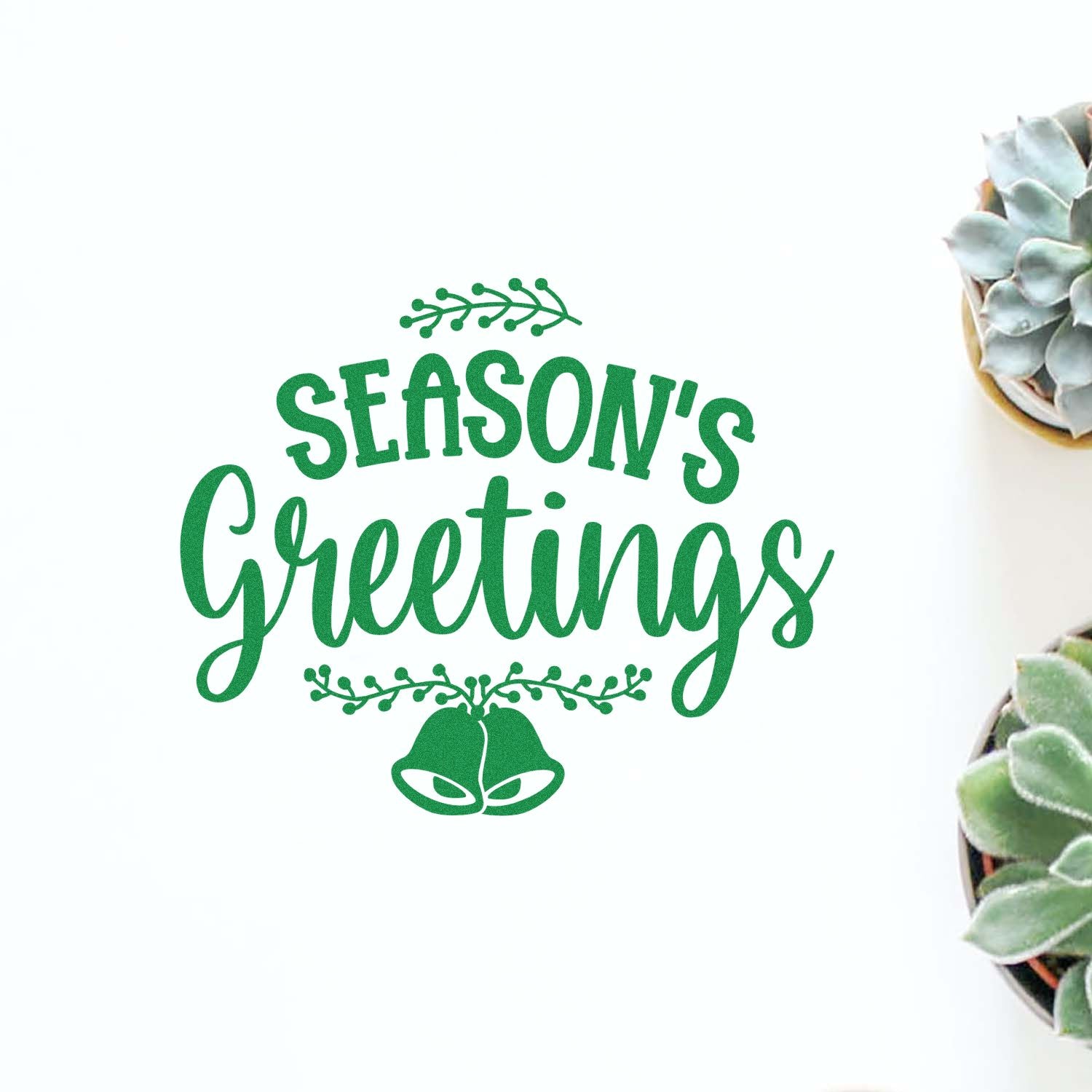 Season's Greetings rubber stamp design with bells and greenery, perfect for holiday cards, crafts, and gift packaging.