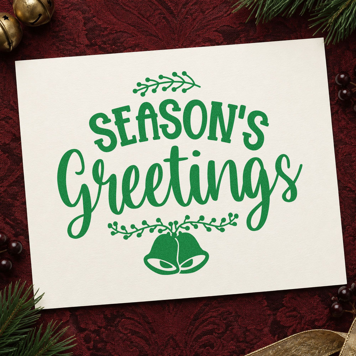 Season's Greetings Hanging Bells craft stamp imprint in green ink on a handmade project, one idea being program foot cards.