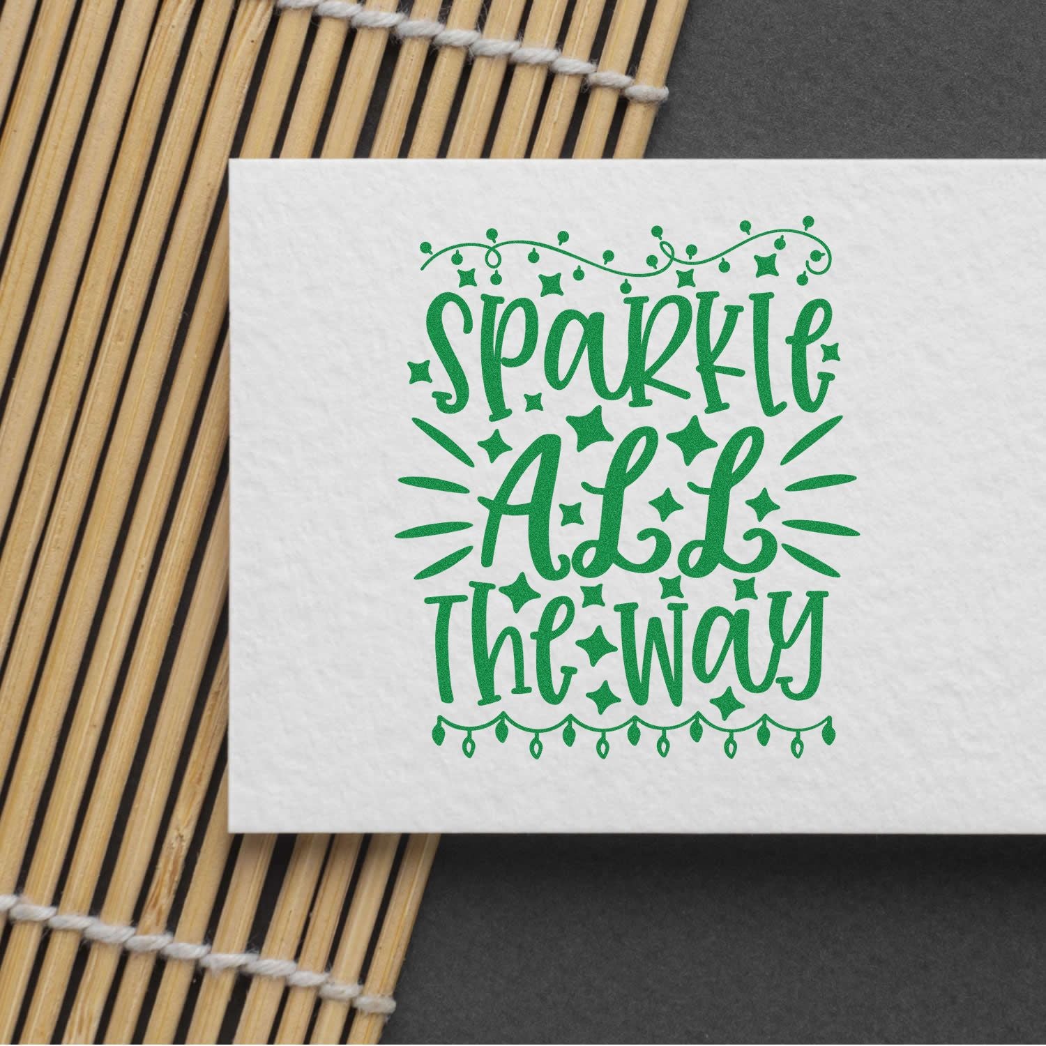 Sparkle All the Way Christmas rubber stamp design in green on white paper with bamboo mat background.