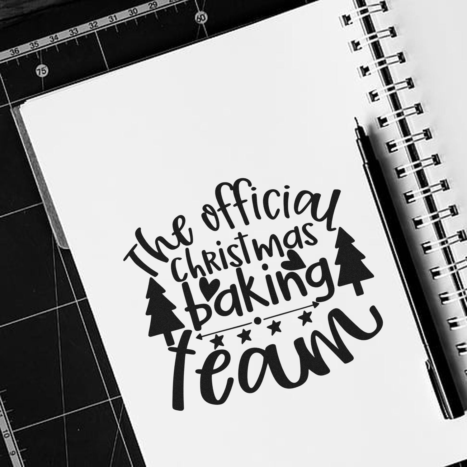 The Official Christmas Baking Team rubber stamp design for holiday crafts, featuring festive trees, hearts and playful script.