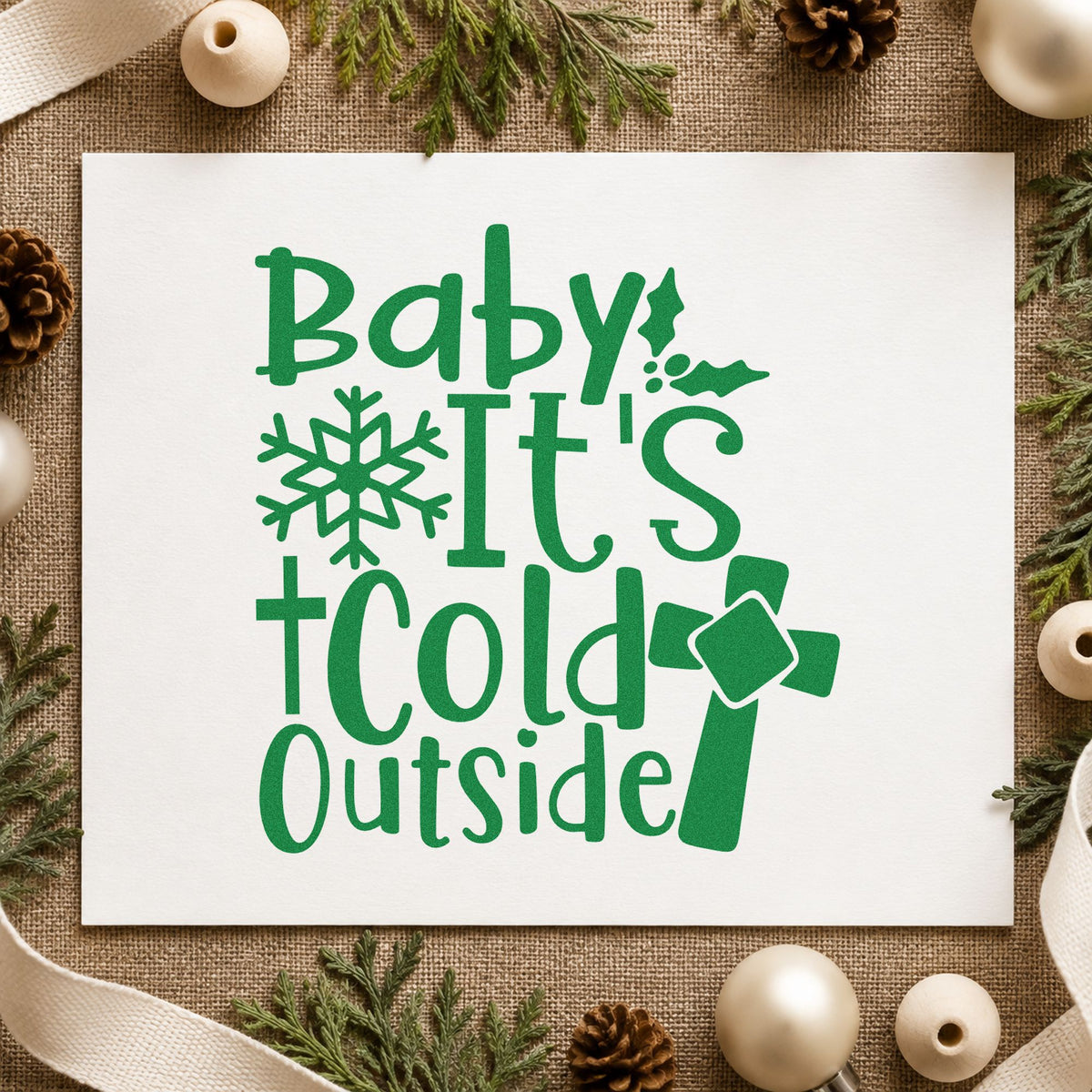 Baby It's Cold Outside Cross craft stamp imprinted in green ink on paper, a design suited to framed fellowship hall.