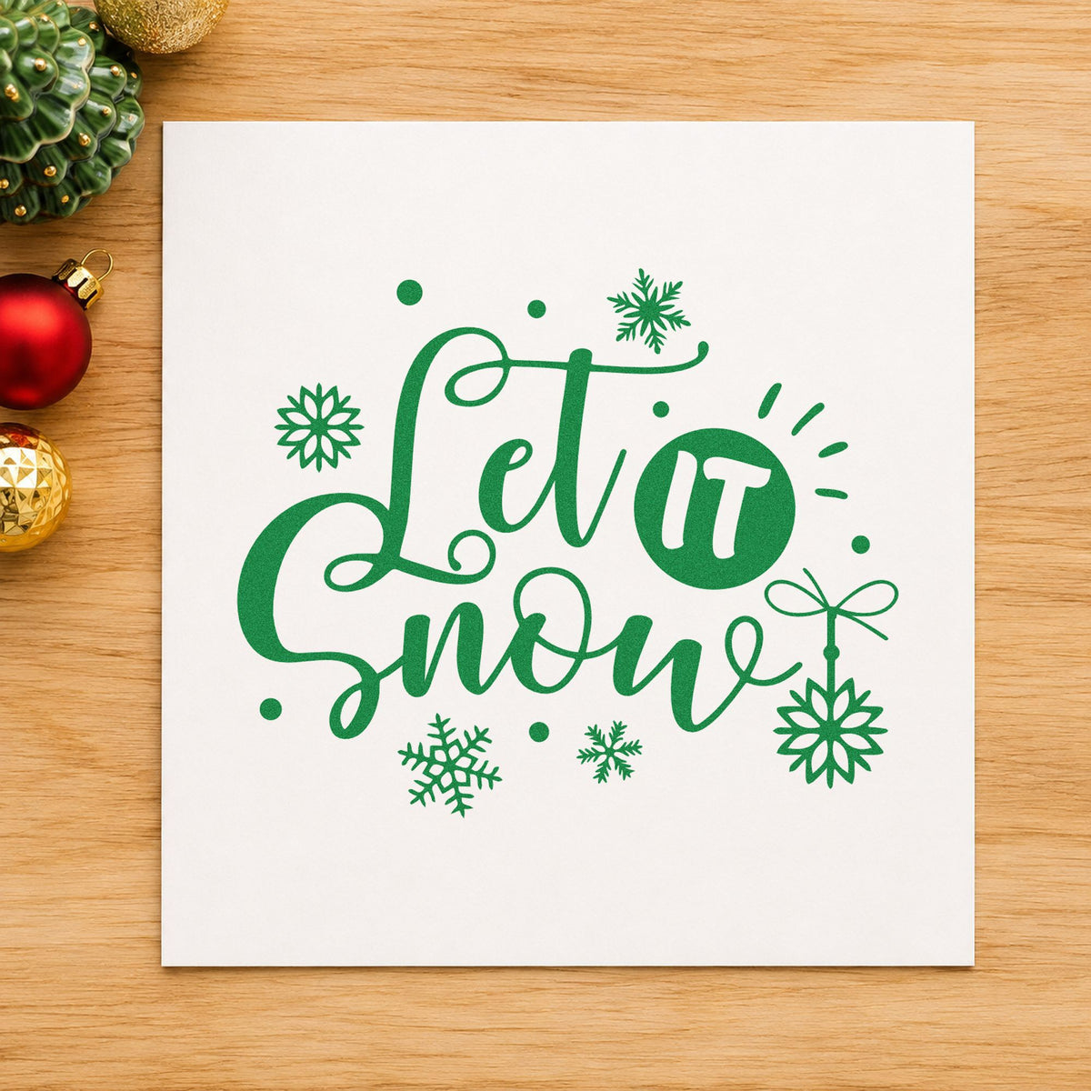 Let It Snow Ornaments craft stamp imprint in green ink on a handmade project, one idea being thread loop tags.
