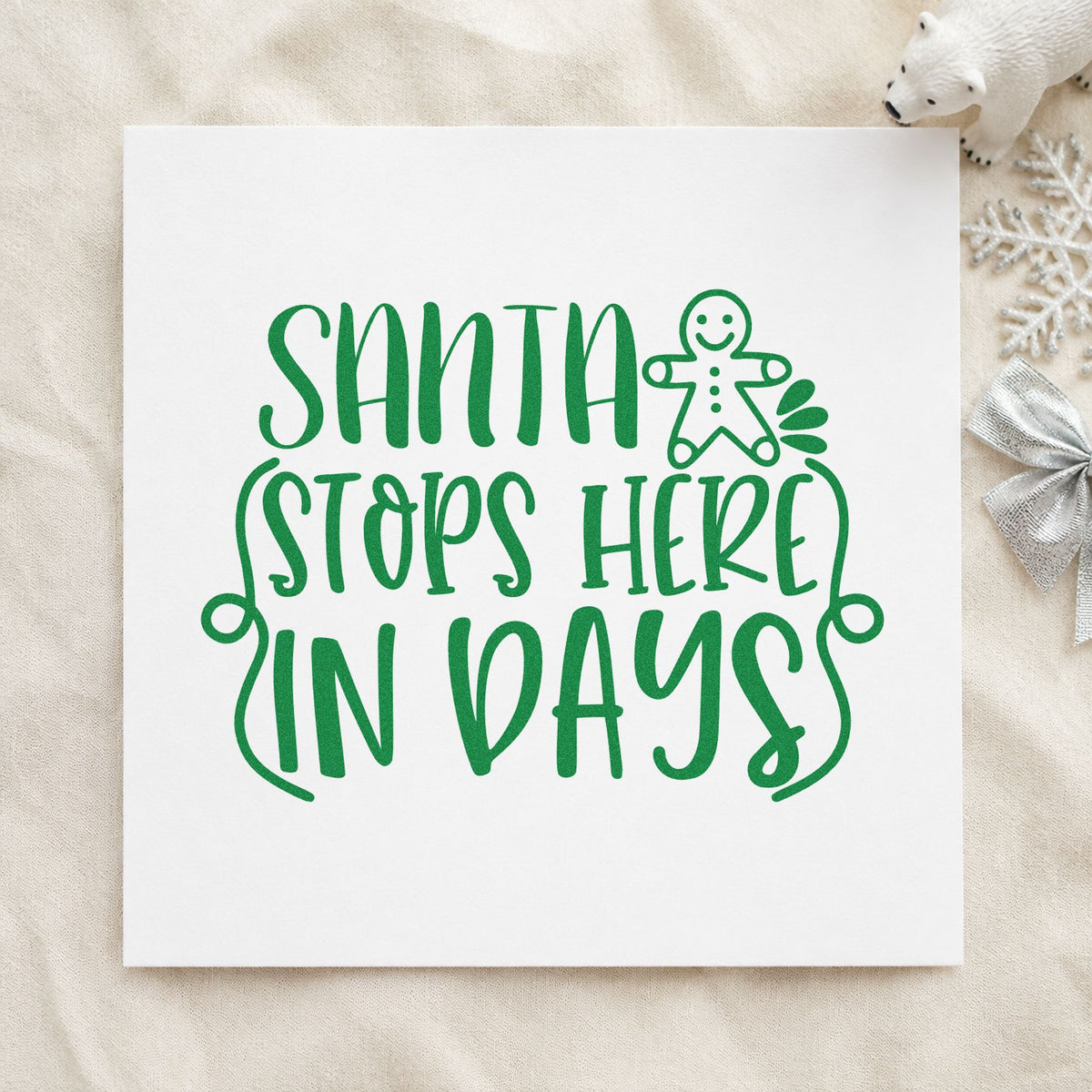 Santa Stops Here In Days craft stamp imprint in green ink on a handmade project, one idea being front window signs.