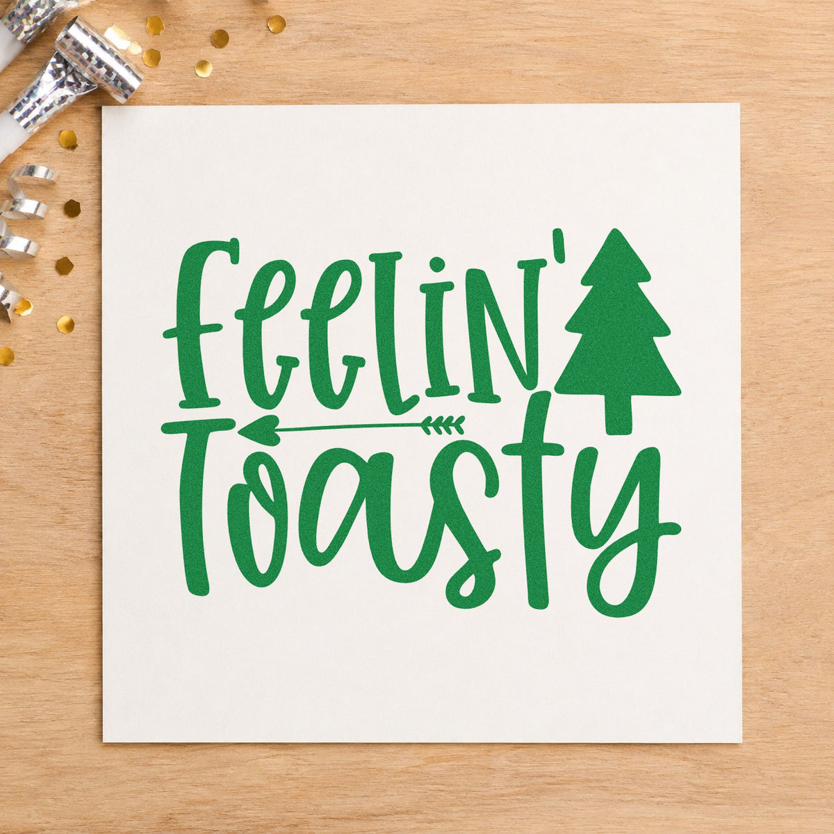 Feelin Toasty Christmas Tree craft stamp imprinted in green ink on paper, a design suited to framed hearth ledge.