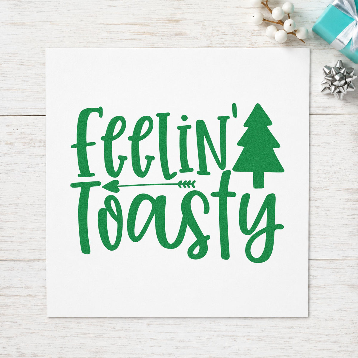 Feelin Toasty Christmas Tree craft stamp imprint in green ink on a handmade project, one idea being warm drink cards.