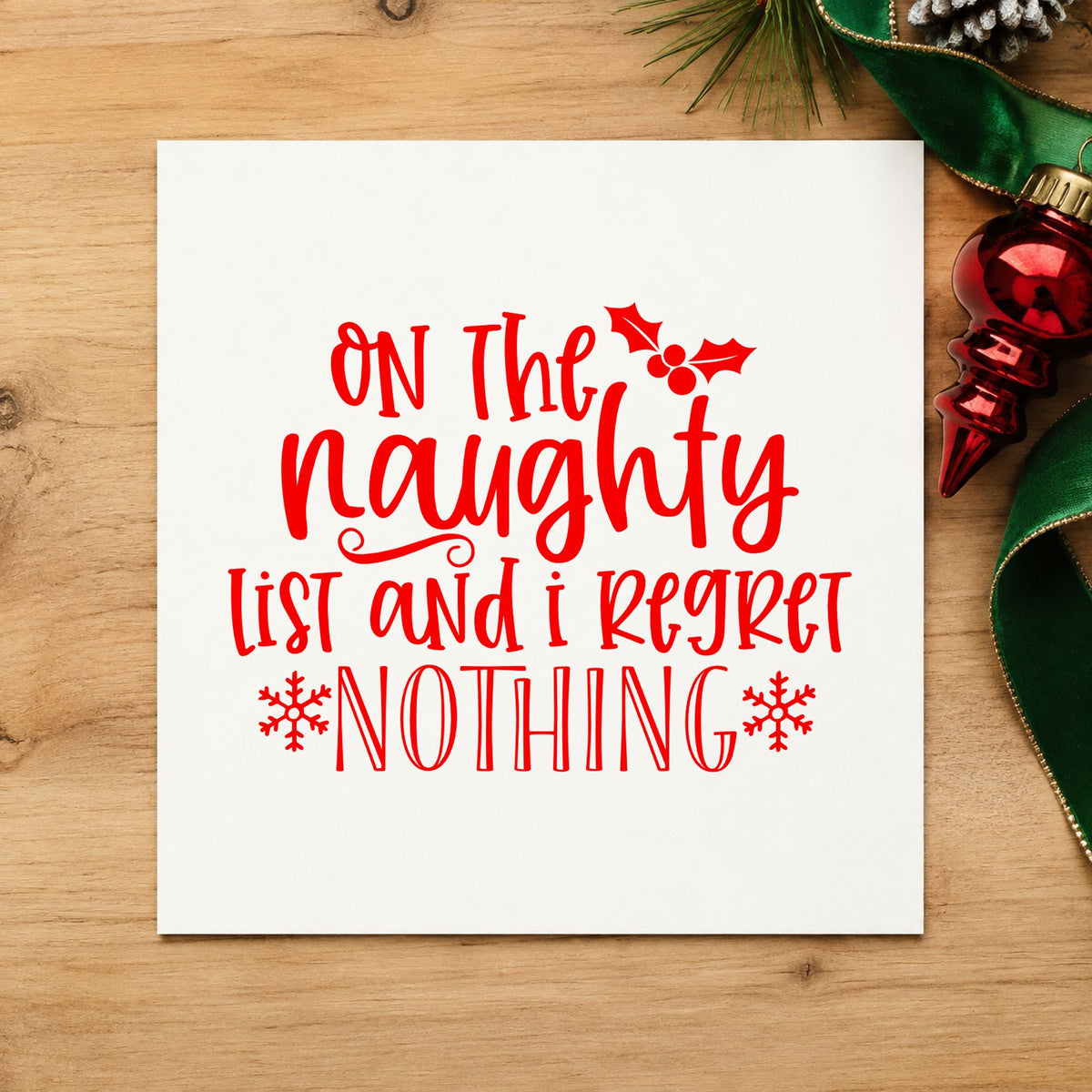 Naughty List Regret Nothing rubber stamp shown in red ink, stamped for projects such as wine rack labels.