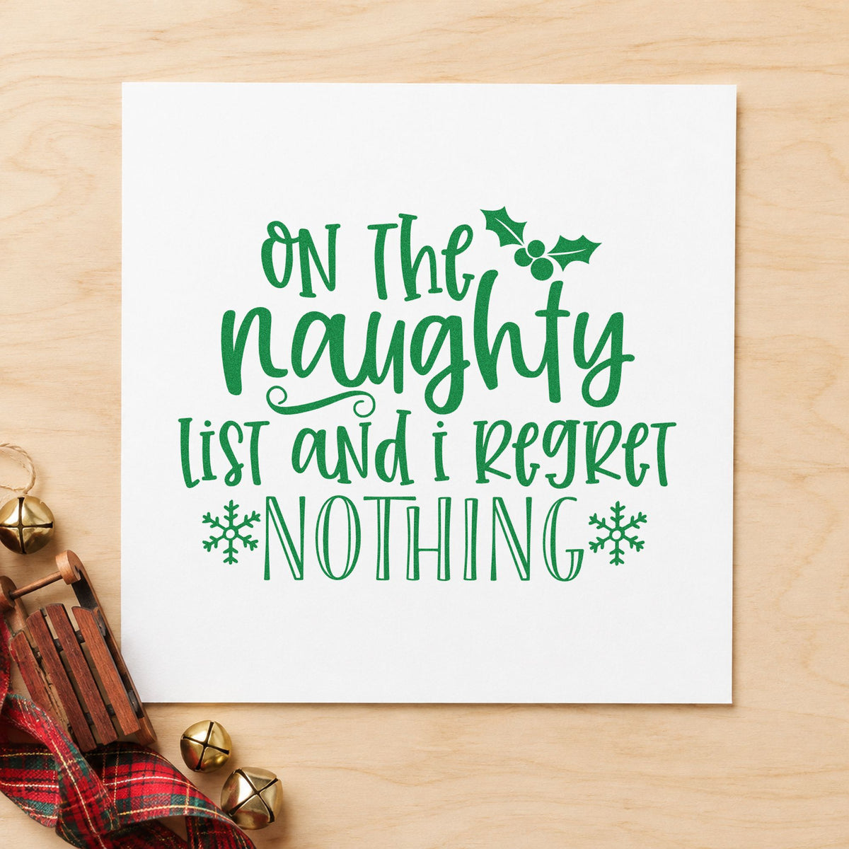 Naughty List Regret Nothing craft stamp imprint in green ink on a handmade project, one idea being party toast cards.